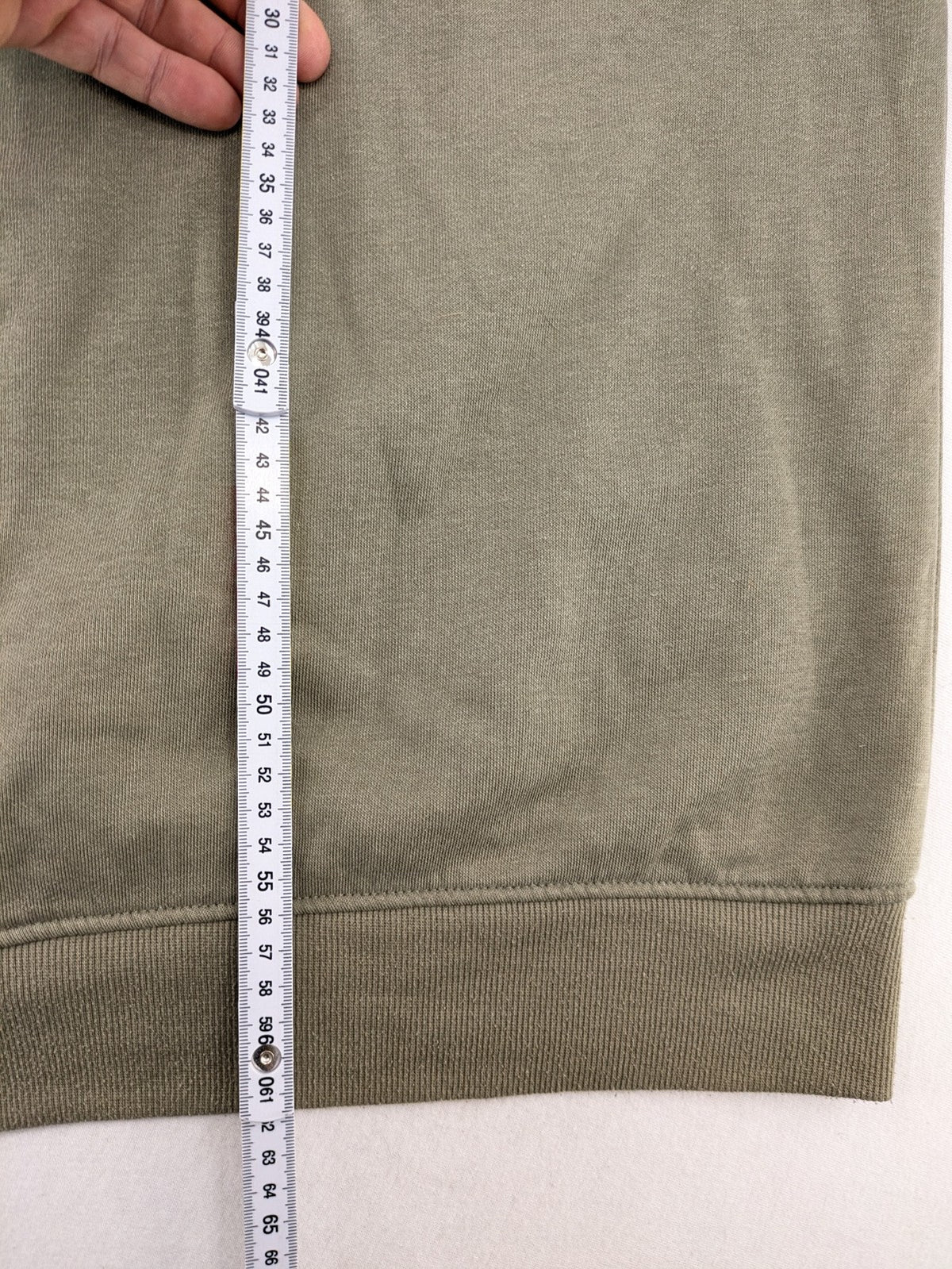 Naruto khaki turtle neck jumper featuring red Akatsuki cloud and Sharingan symbols.