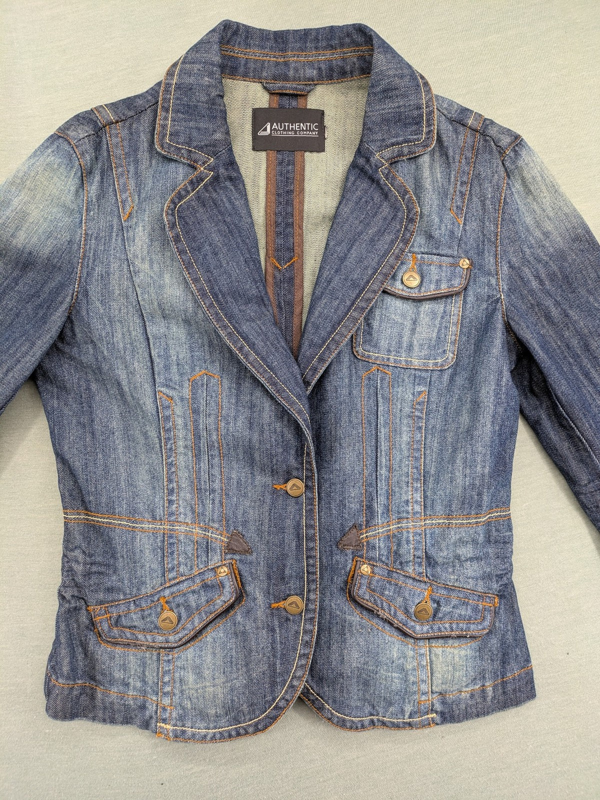 Authentic Clothing Company blue jeans blazer with contrast stitching and button closure.