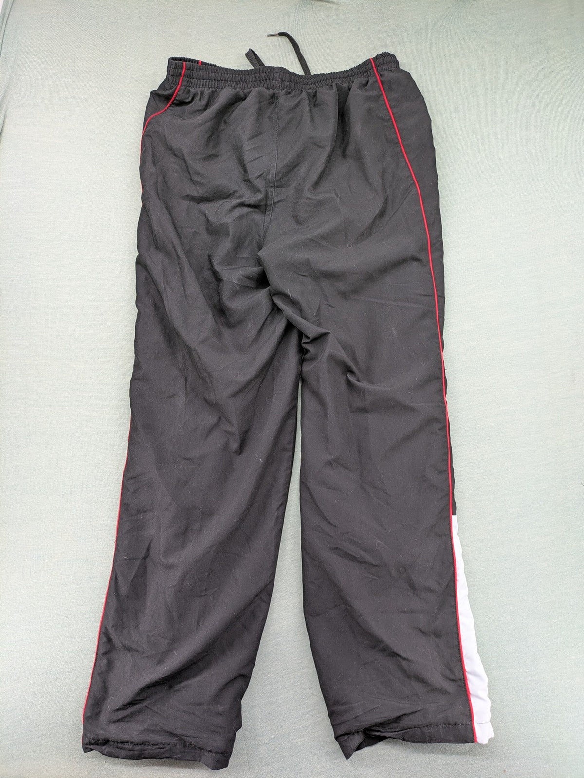Fila grey jogging pants with red piping and embroidered logo on thigh.