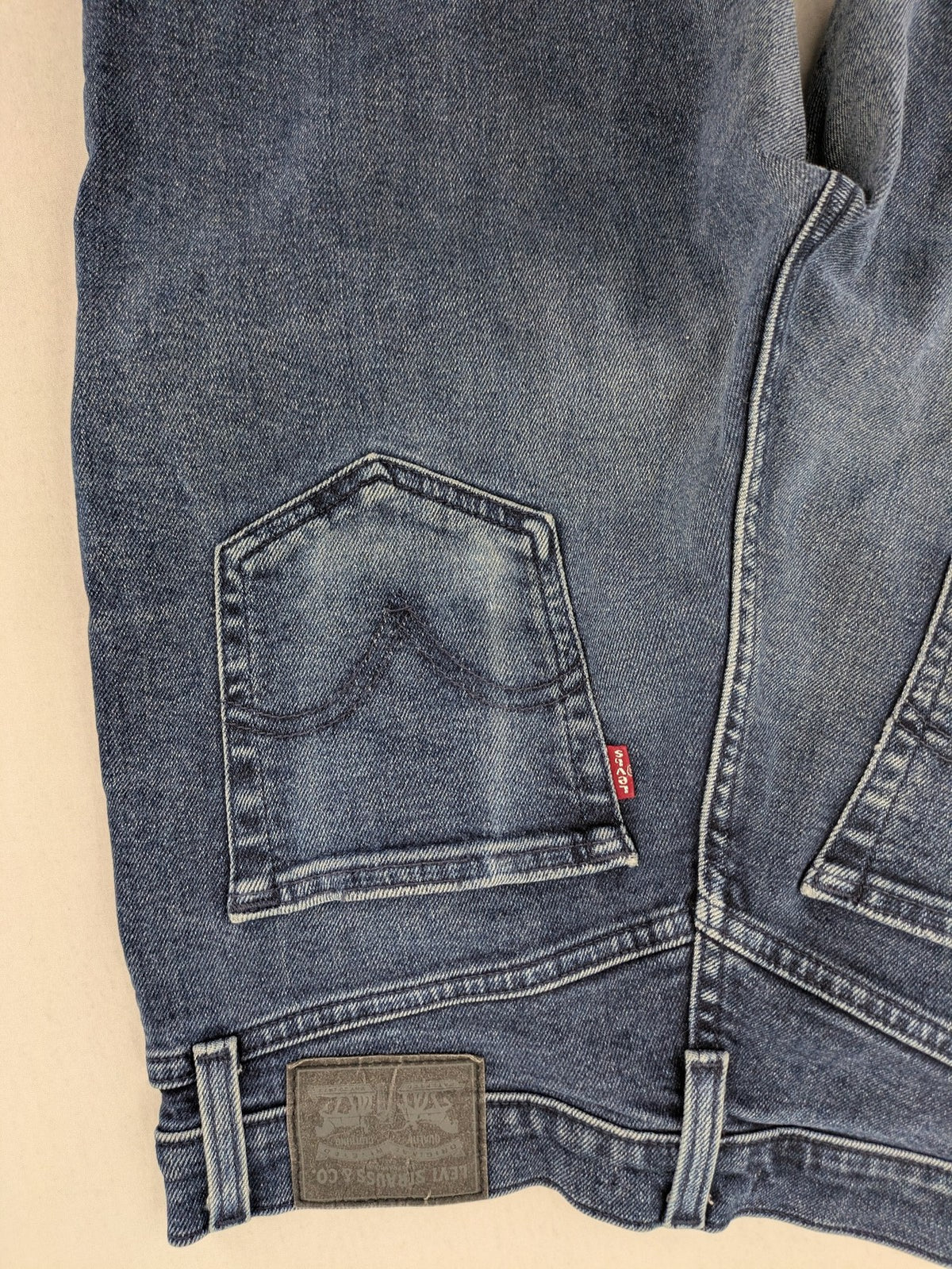Levi's high waisted taper jeans dark blue 5-pocket design with zipper and stretch material.