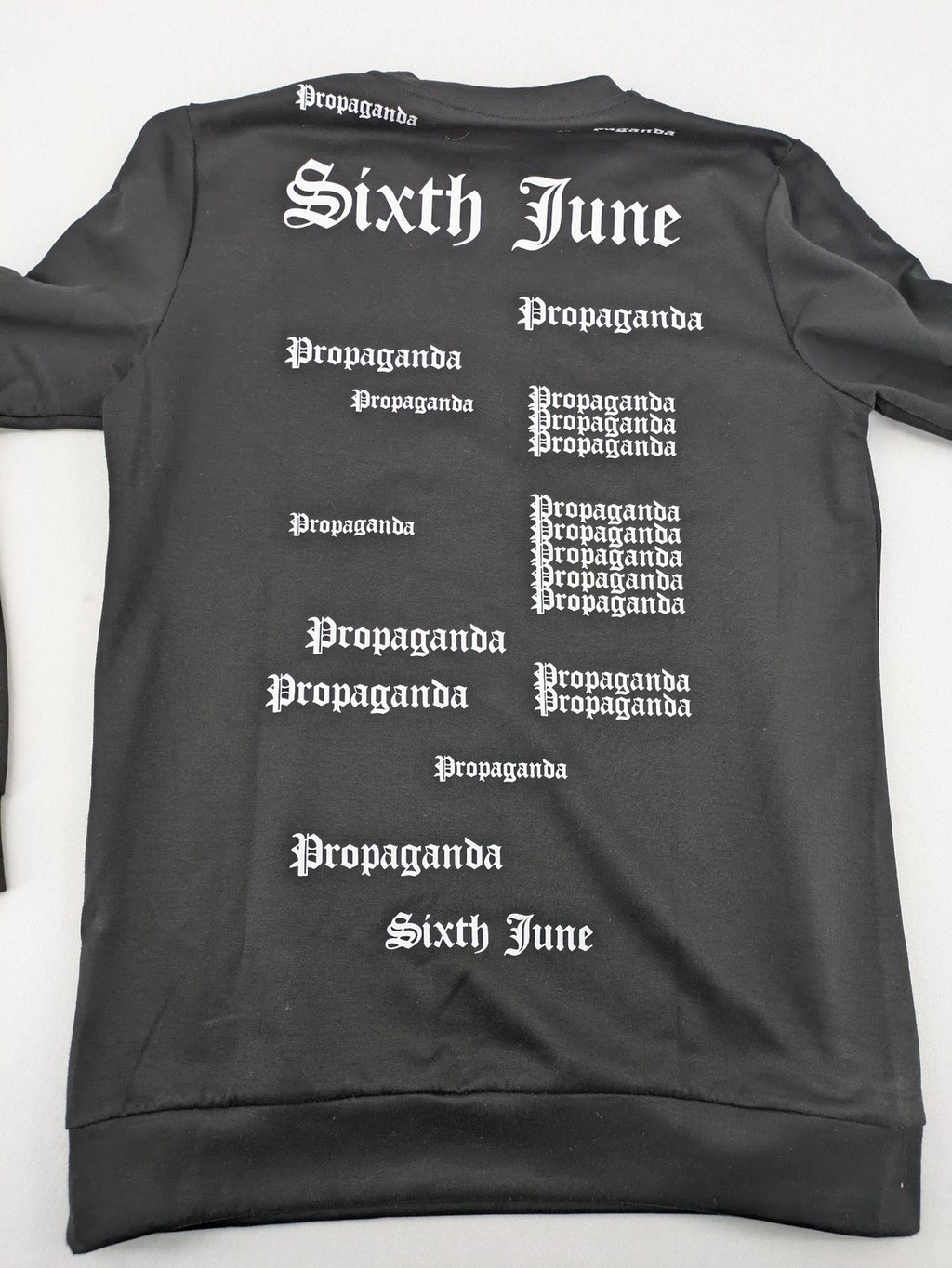Sixth June black sweatshirt with Gothic "Propaganda" graphic print and logo details.