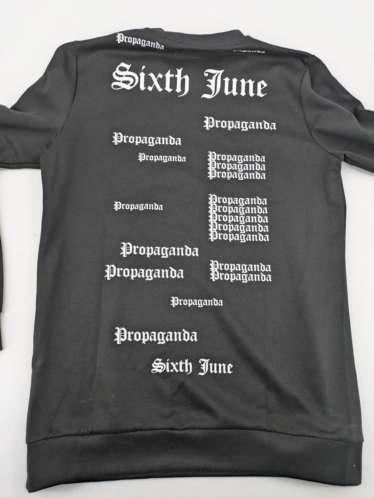 Sixth June black sweatshirt with Gothic "Propaganda" graphic print and logo details.