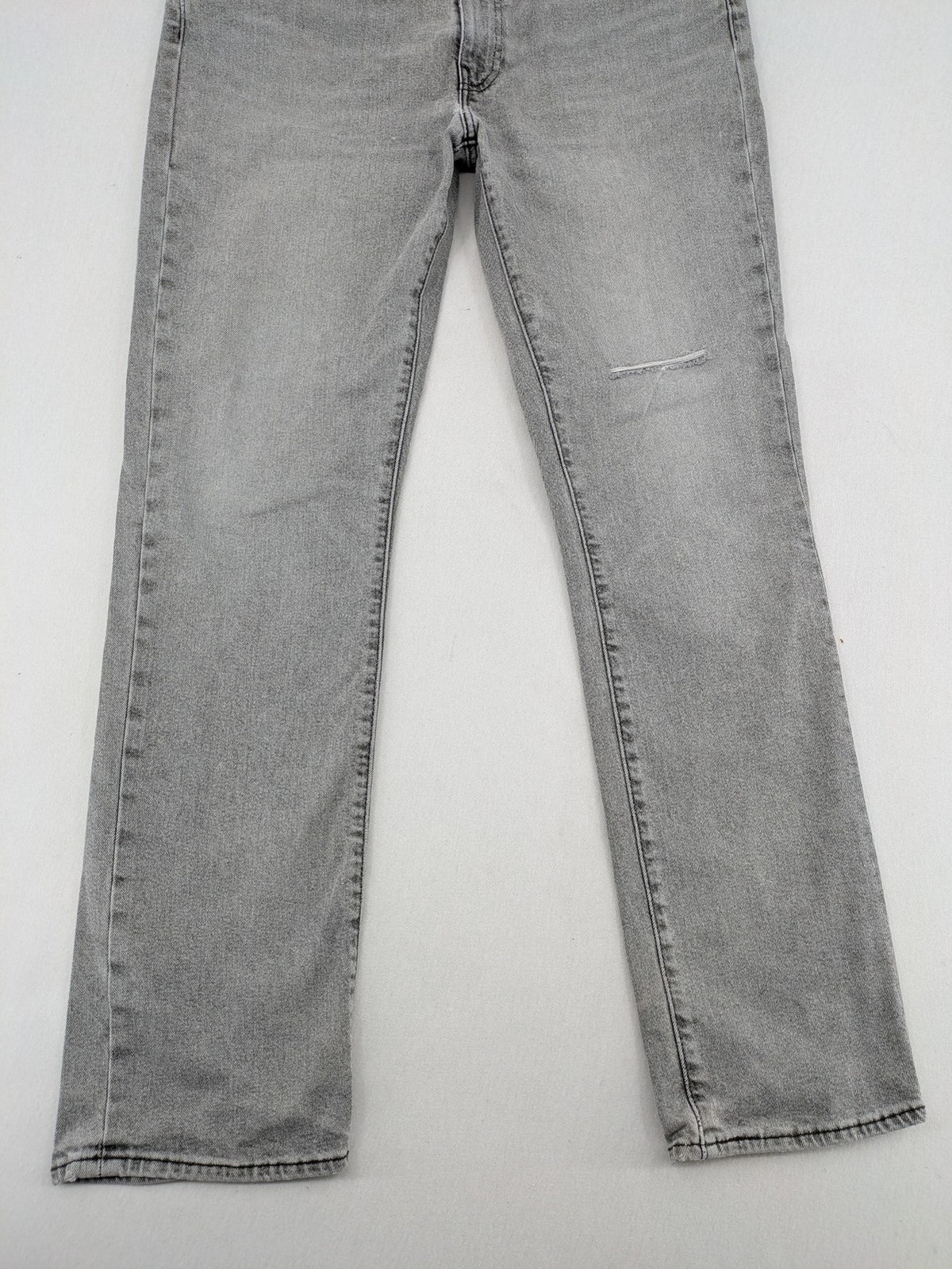 Levi's grey slim fit jeans with distressed knee details and classic logo patch.
