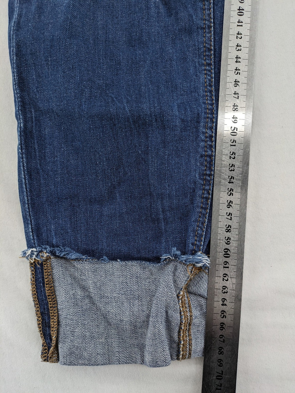 Esprit blue straight leg jeans with ripped knee details and rolled hem.