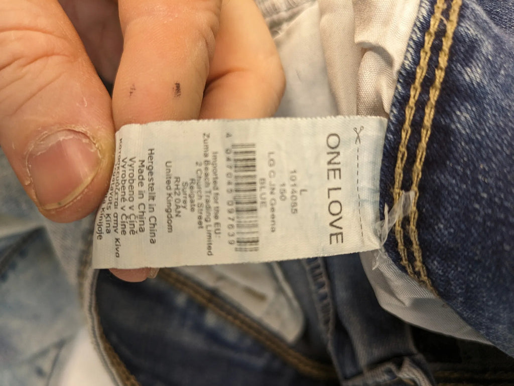 ONE LOVE DENIM blue straight jeans with distressed details and double button closure.