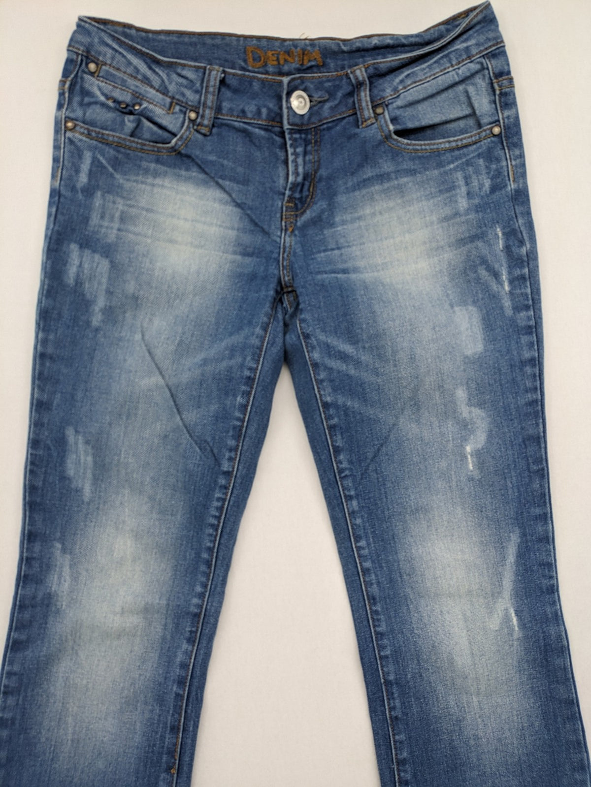 Denim blue straight jeans low rise bootcut with classic 5-pocket design and subtle rivets.