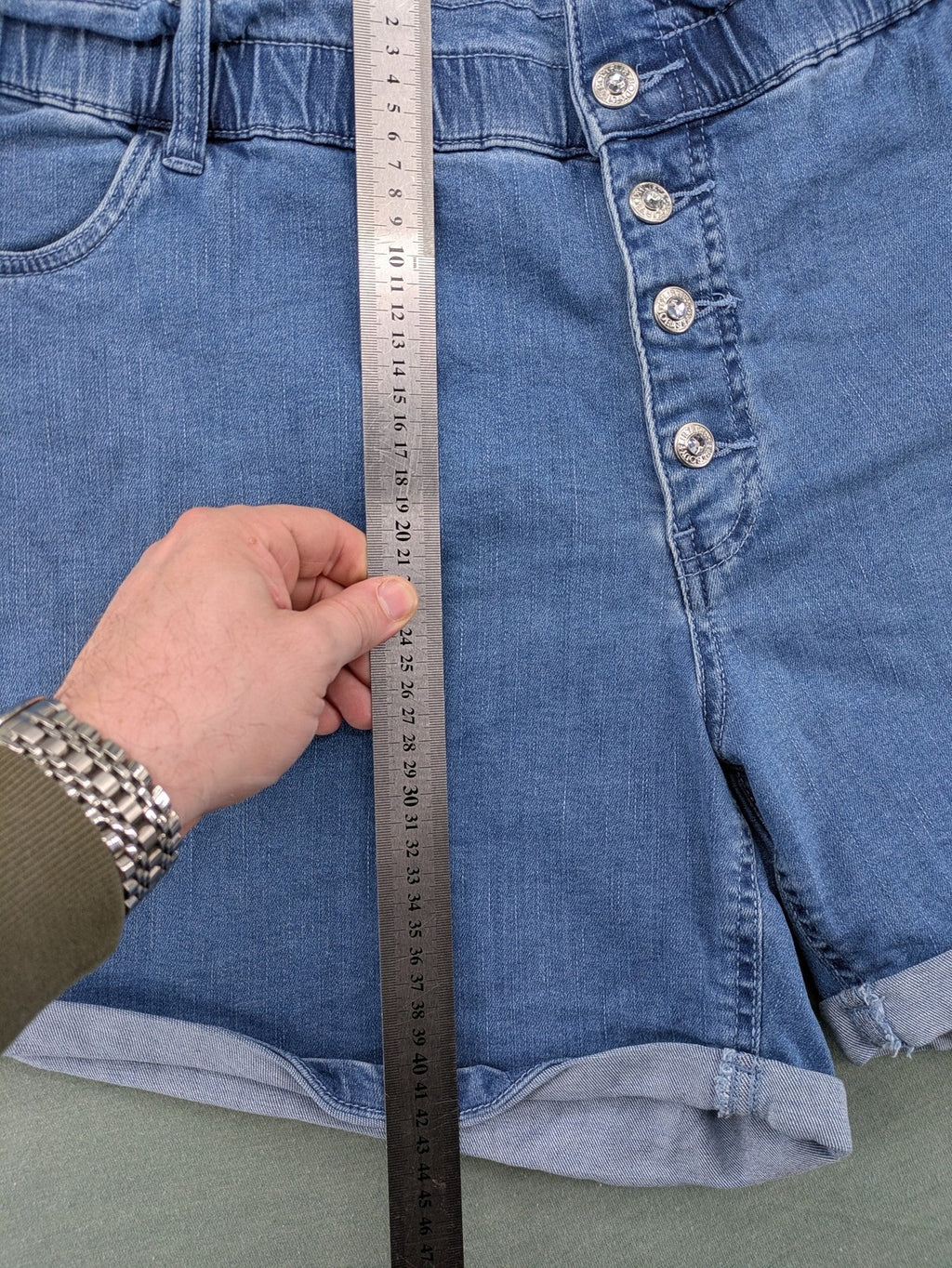 Bodyflirt blue high waist paperbag jeans shorts with button fly and rolled cuffs.