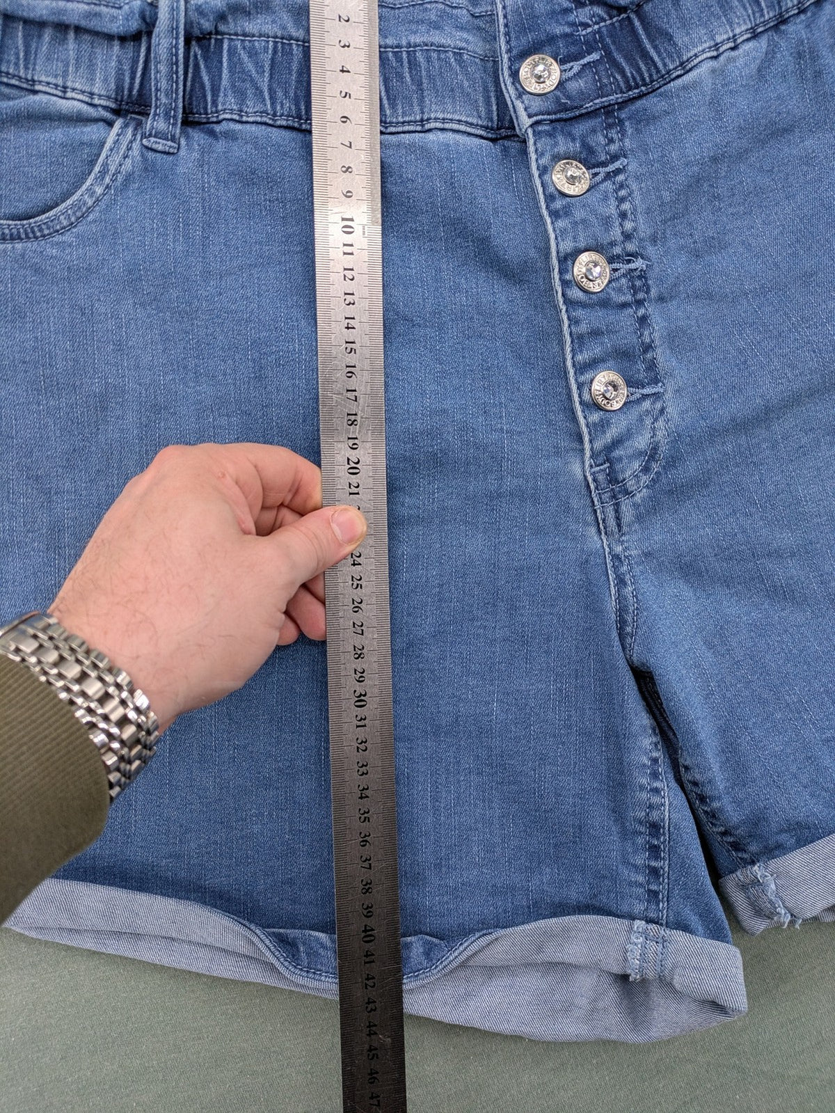 Bodyflirt blue high waist paperbag jeans shorts with button fly and rolled cuffs.