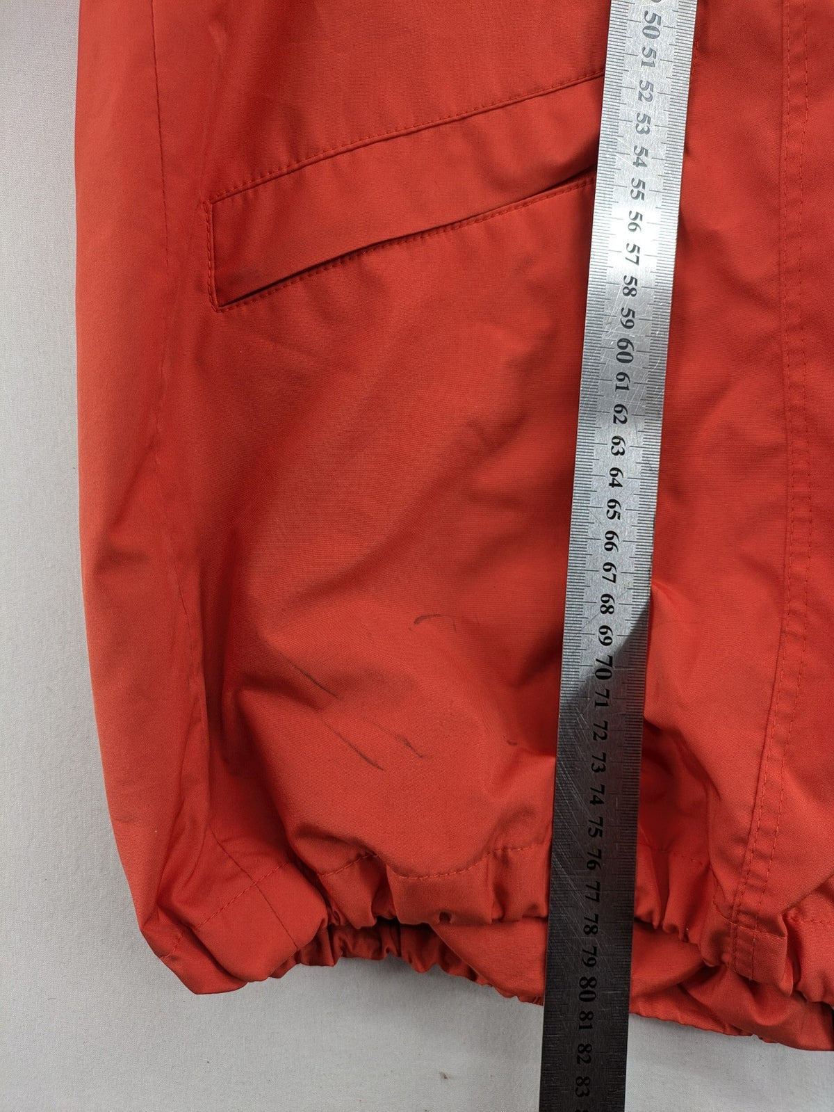 Sport Windbreaker orange jacket with adjustable hood, full zip, and button storm flap.