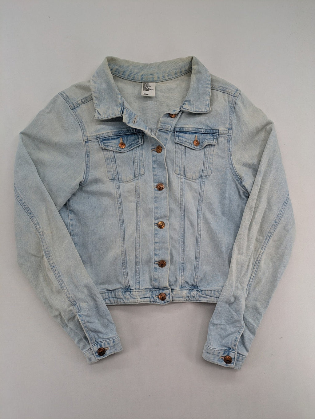 H&M denim jacket light blue classic trucker style with button placket and chest pockets.