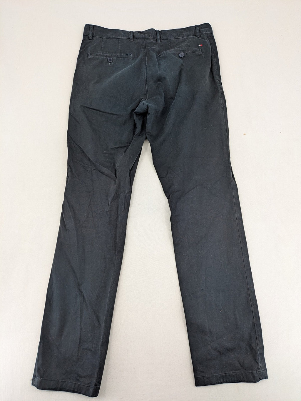 Tommy Hilfiger grey chino pants with TH-Flex stretch technology and classic straight fit design.