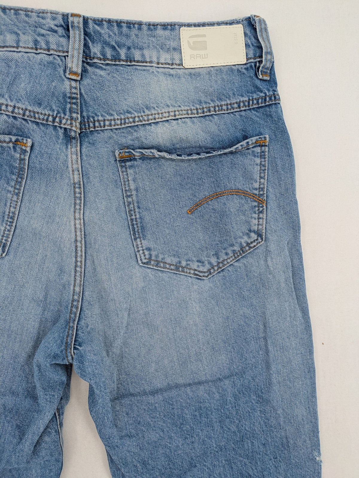 G-Star Raw blue distressed high boyfriend jeans with ripped details and classic button closure.