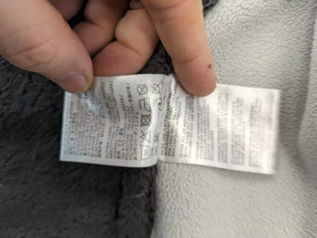 Jack Wolfskin grey fleece jacket with logo detailing and two front pockets.