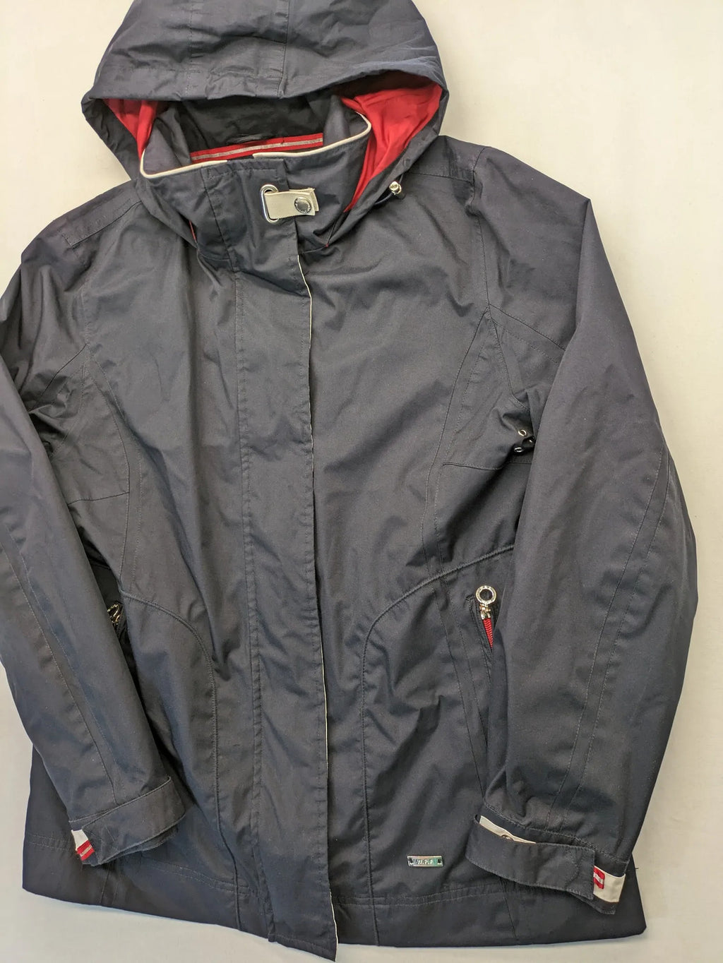 WPF grey outdoor jacket with red lining, zip closure, and hood.