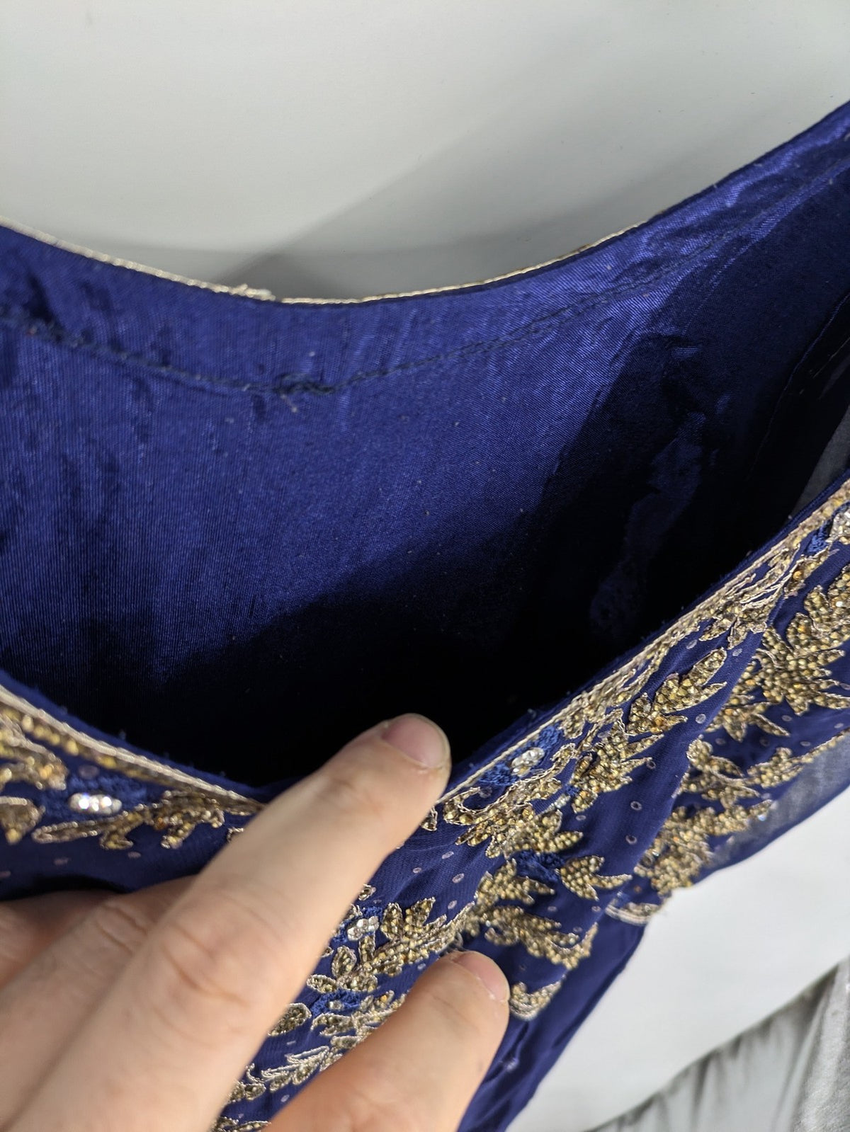 Bollywood bridal party dress gold with intricate blue embroidery and flowing Anarkali silhouette.