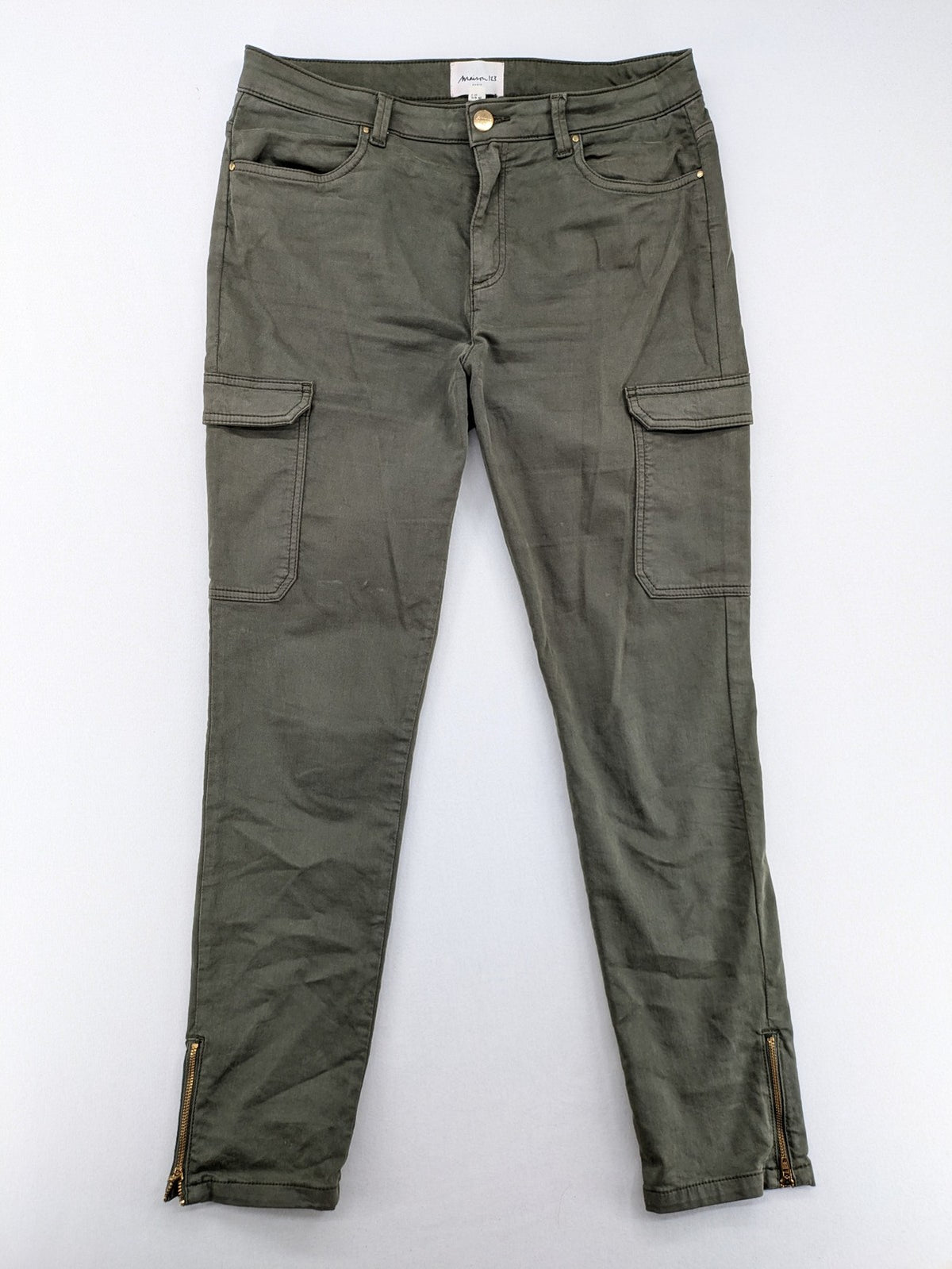 Maison 123 green cargo pants with ankle zippers and gold metal details.
