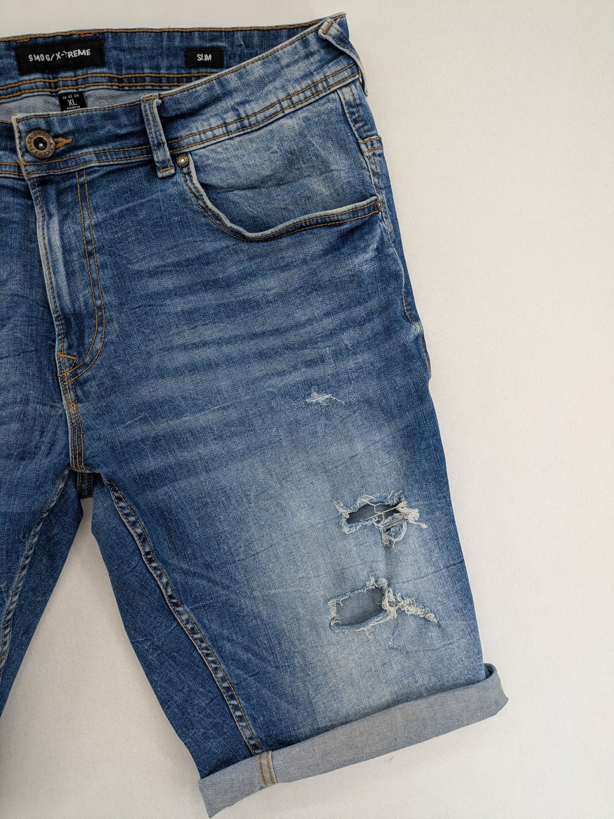 Smog blue denim shorts slim fit distressed details with rolled hem.