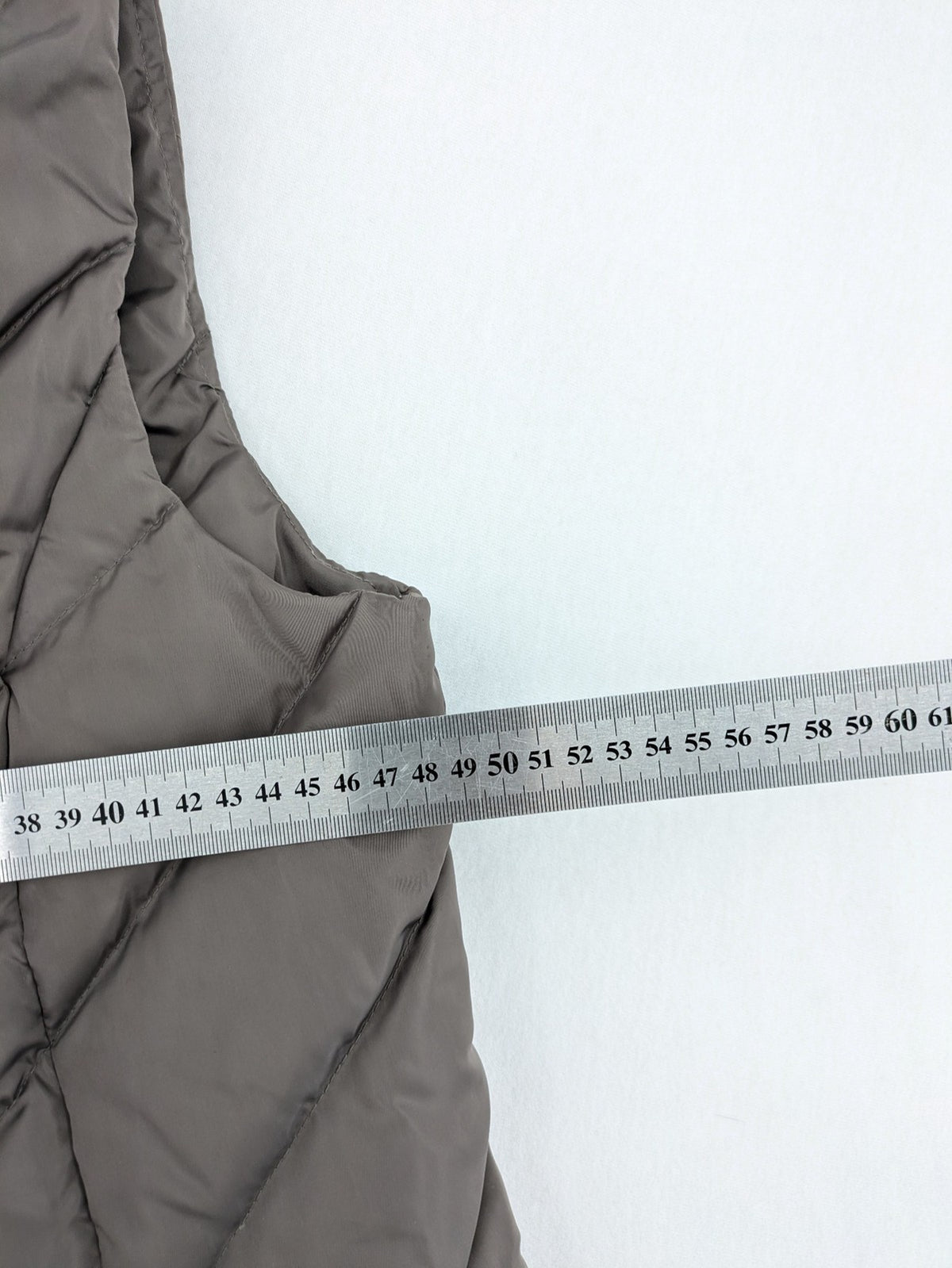 L&A Fashion grey puffer vest with zip closure, stand collar, and side pockets.