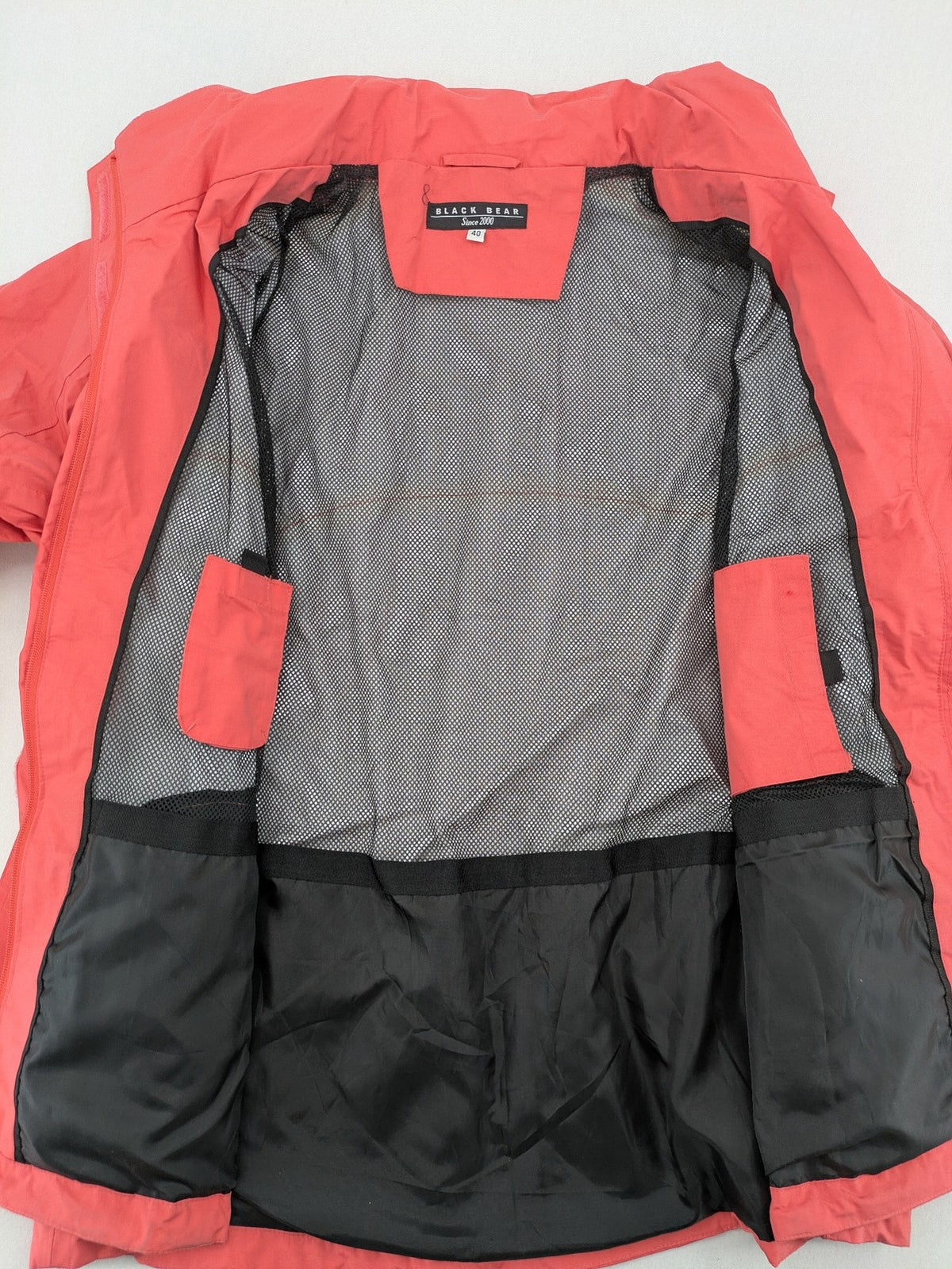 Black Bear black rain jacket with coral pink mesh lining and full zipper.