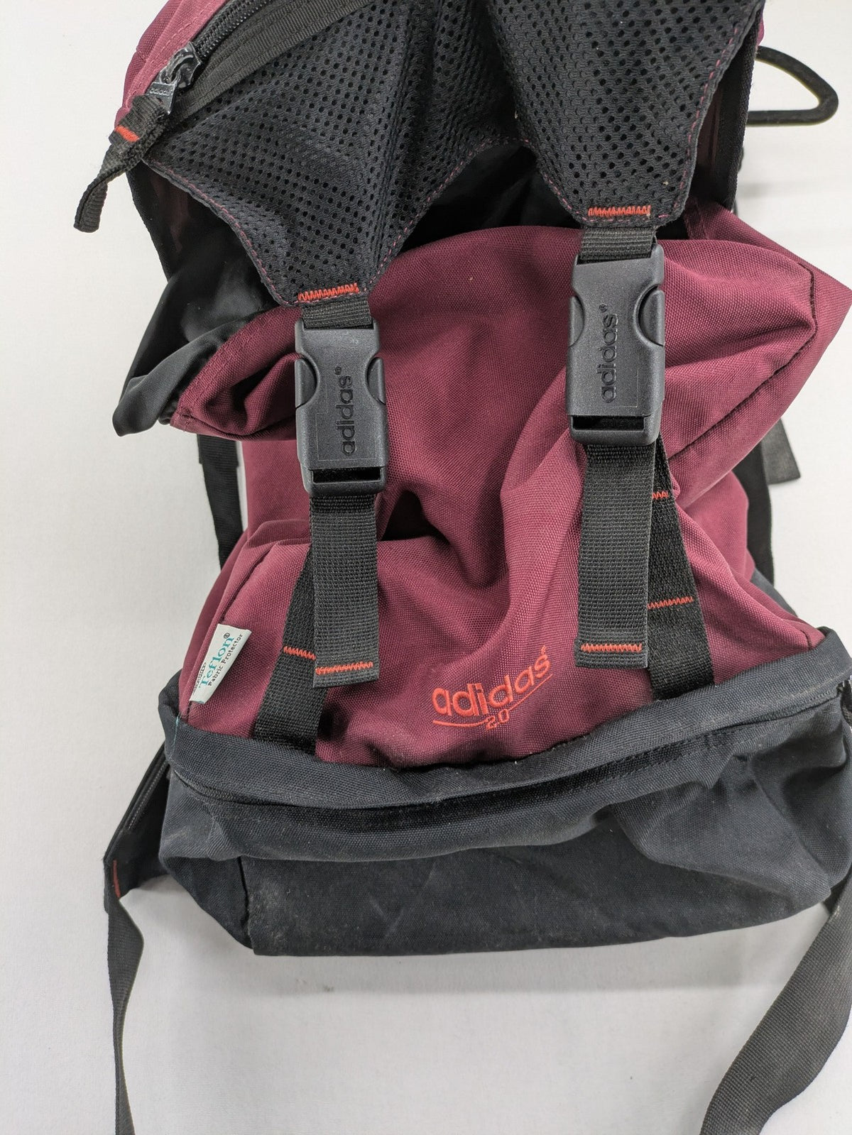 Adidas burgundy vintage rucksack with logo, Teflon fabric, and drawstring closure.