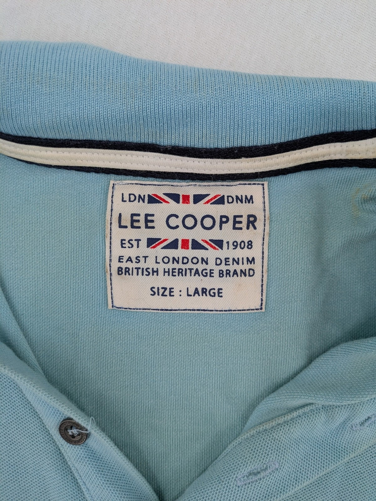Lee Cooper blue polo shirt with embroidered logo and Union Jack patch on sleeve.