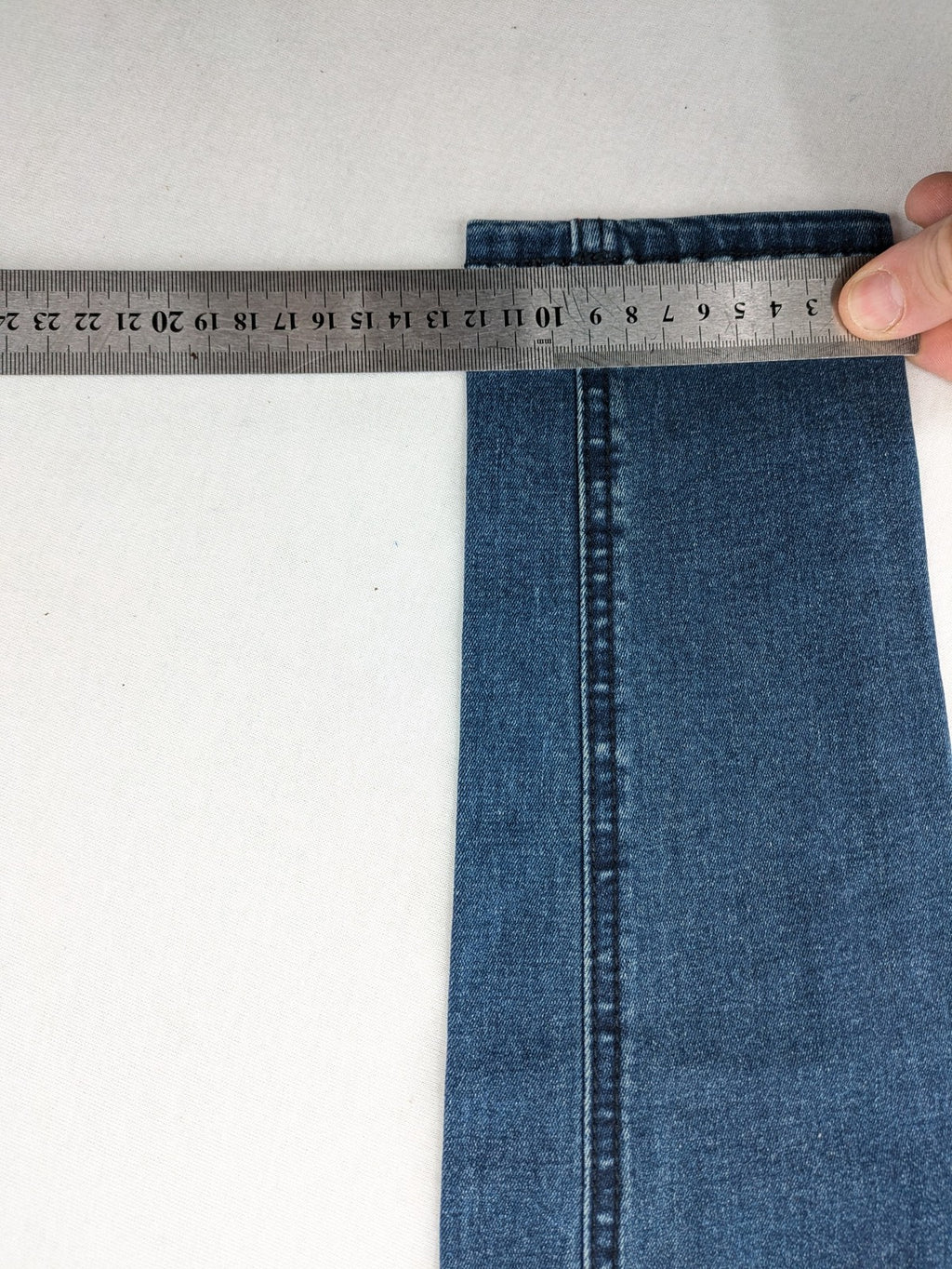 Dust blue skinny jeans with mid-rise waist and classic wash, stretch denim material.