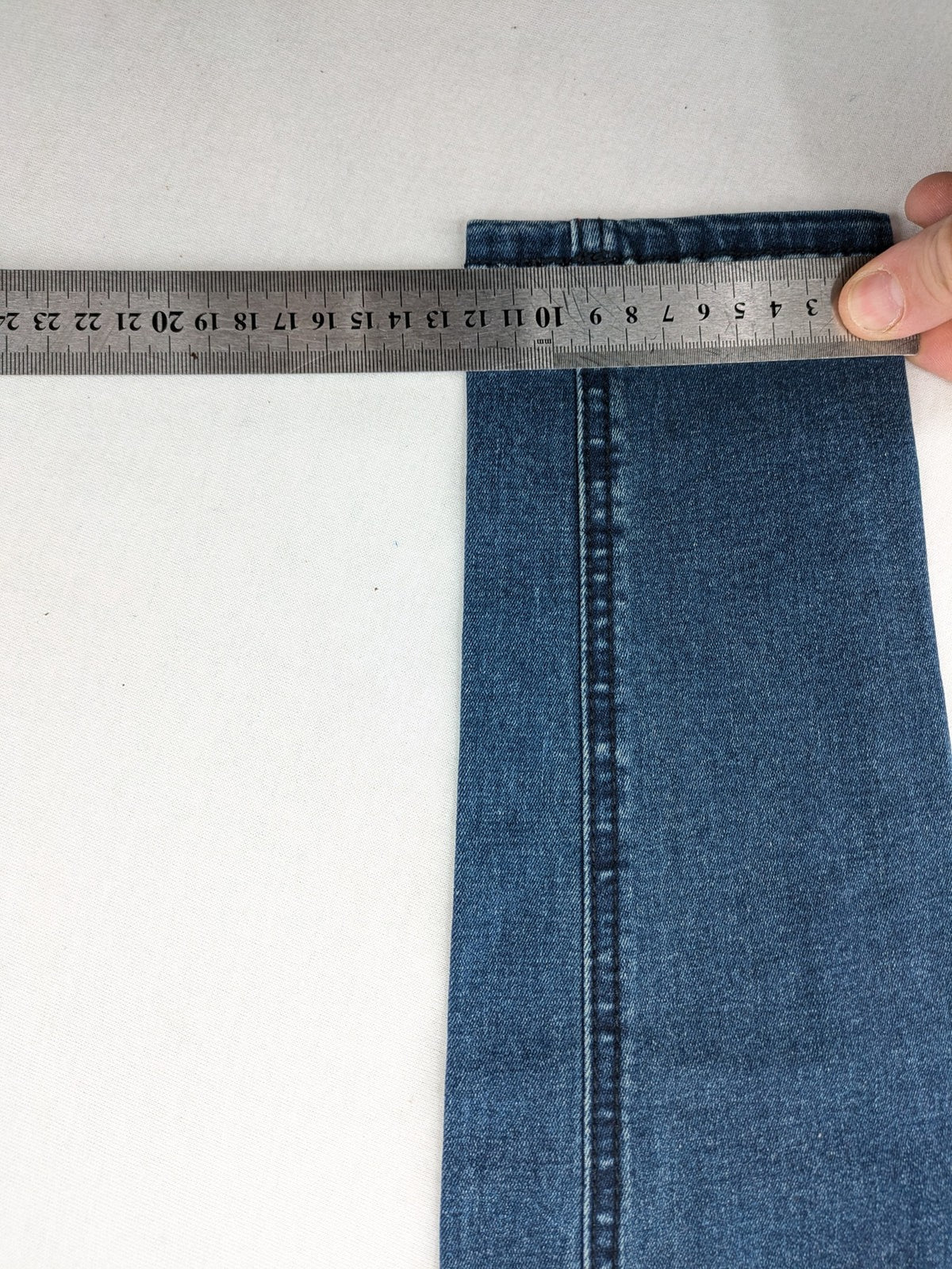 Dust blue skinny jeans with mid-rise waist and classic wash, stretch denim material.
