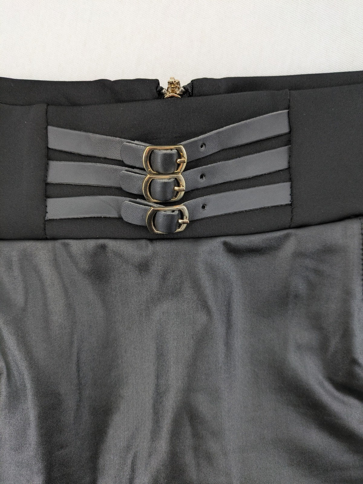 Romatie black mini bodycon skirt satin finish high waist with gold zippers and buckles.