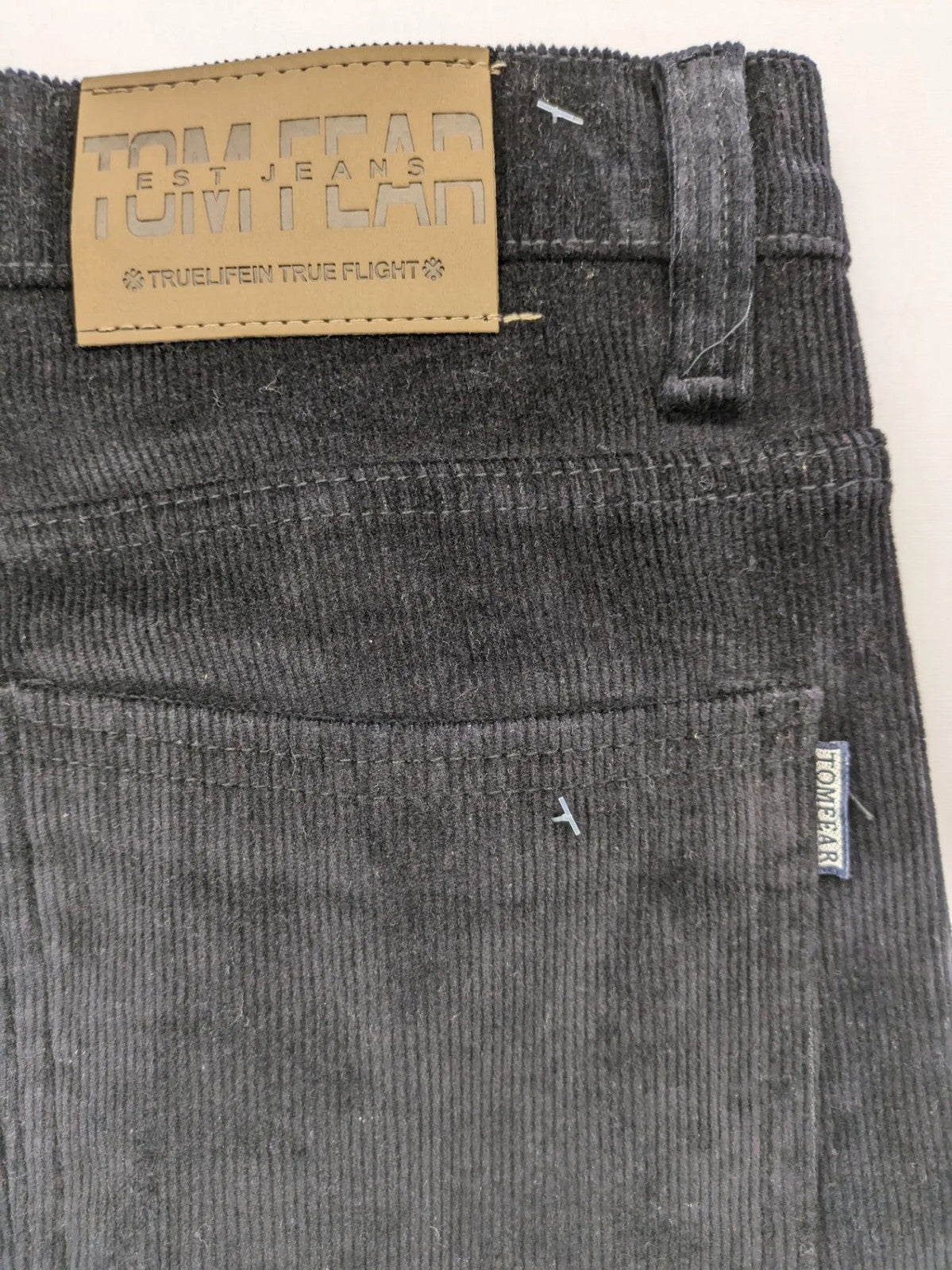 Tomfear black straight fit cord jeans, classic five-pocket design, soft corduroy material.