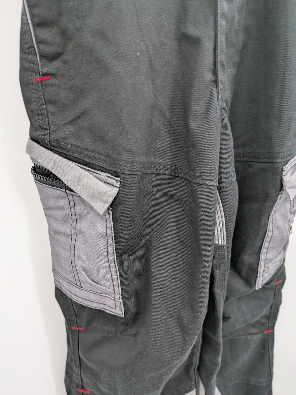 Cargo pants black grey two-tone design with red stitching and multiple pockets