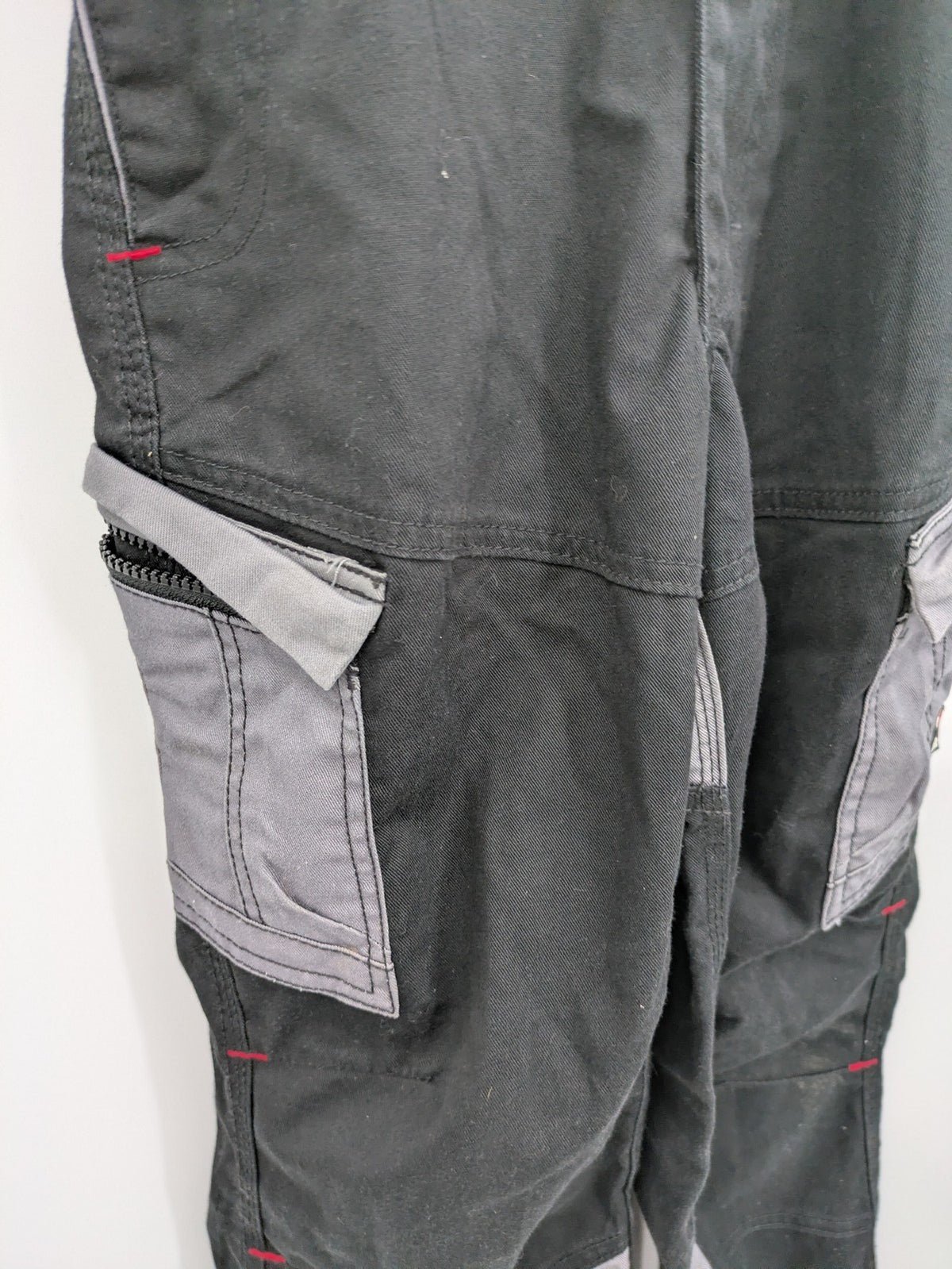 Cargo pants black grey two-tone design with red stitching and multiple pockets