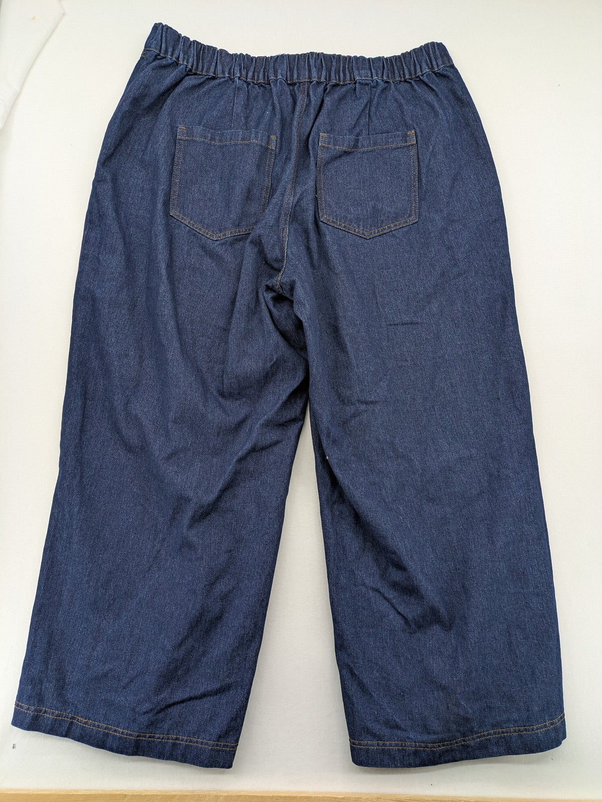 Emery Rose pink culotte pants with wide legs, double button closure, and soft denim blend.
