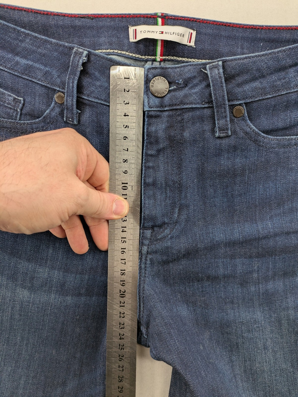 Tommy Hilfiger blue straight jeans with iconic logo and dark wash denim finish.