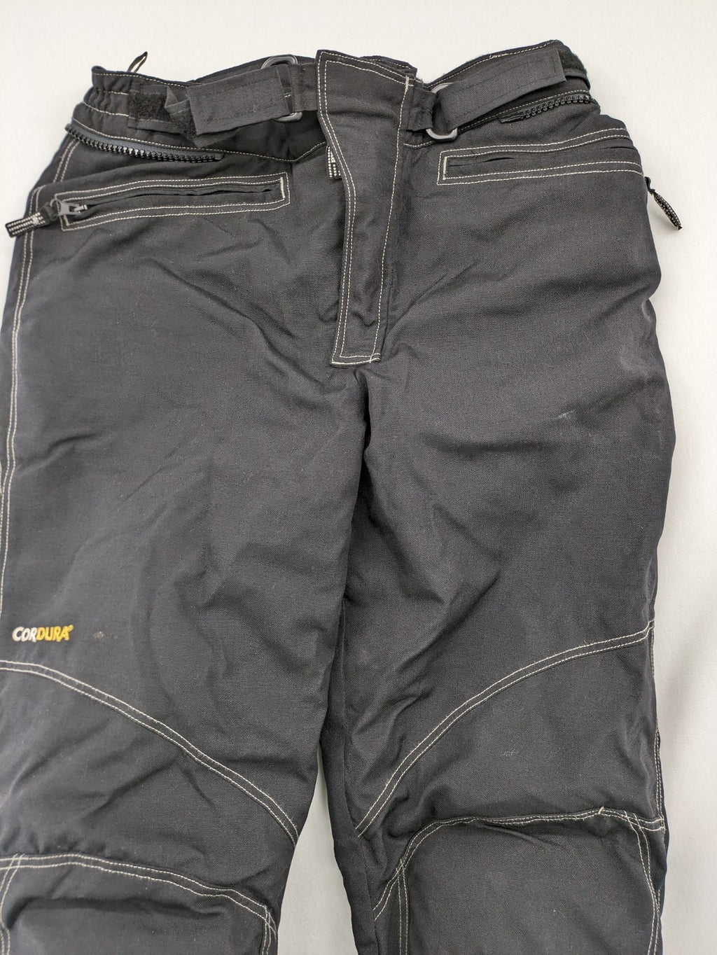 Rukka black motorcycle chaps with grey accents and CE knee protectors, made from durable Cordura.