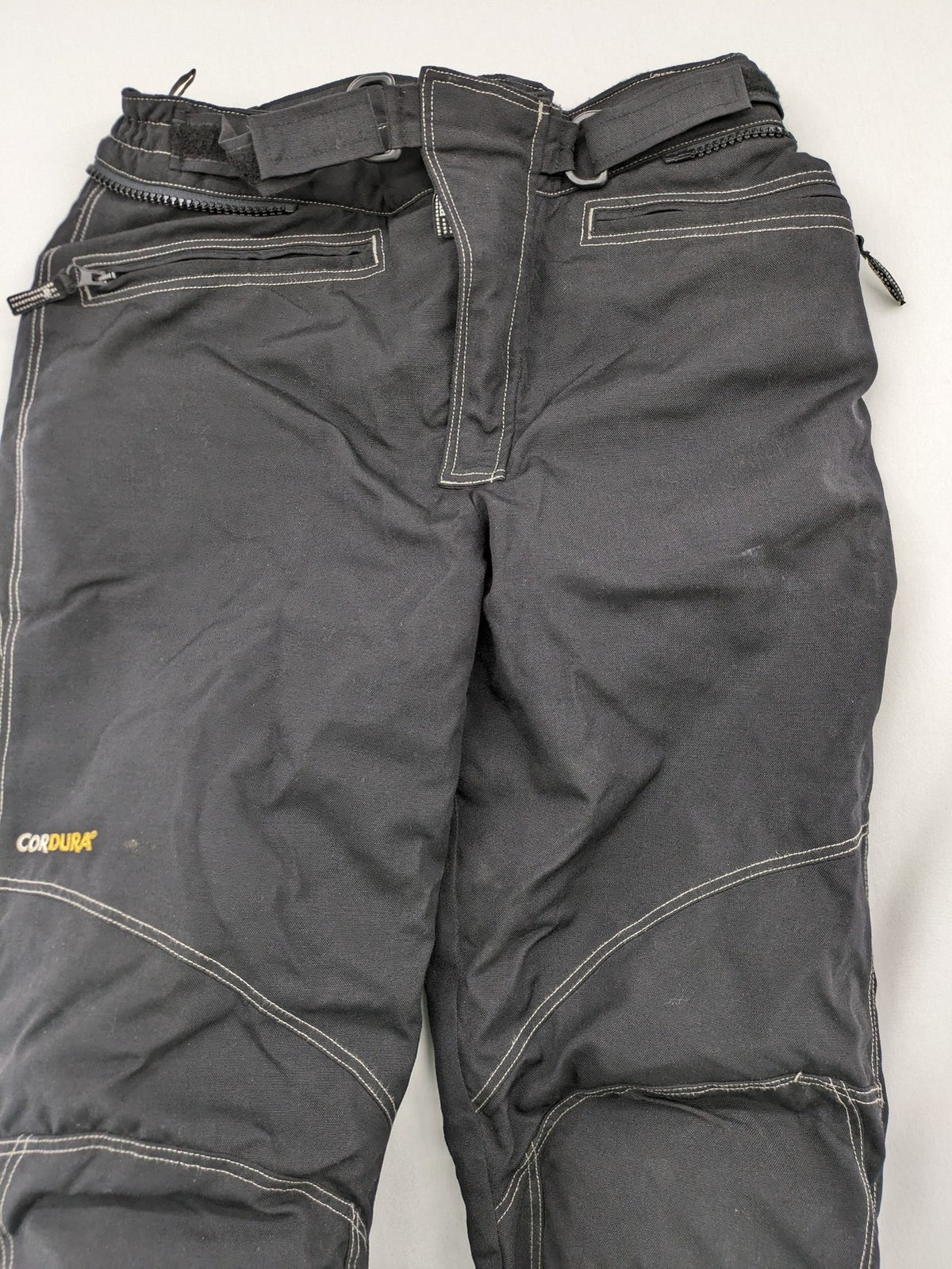 Rukka black motorcycle chaps with grey accents and CE knee protectors, made from durable Cordura.
