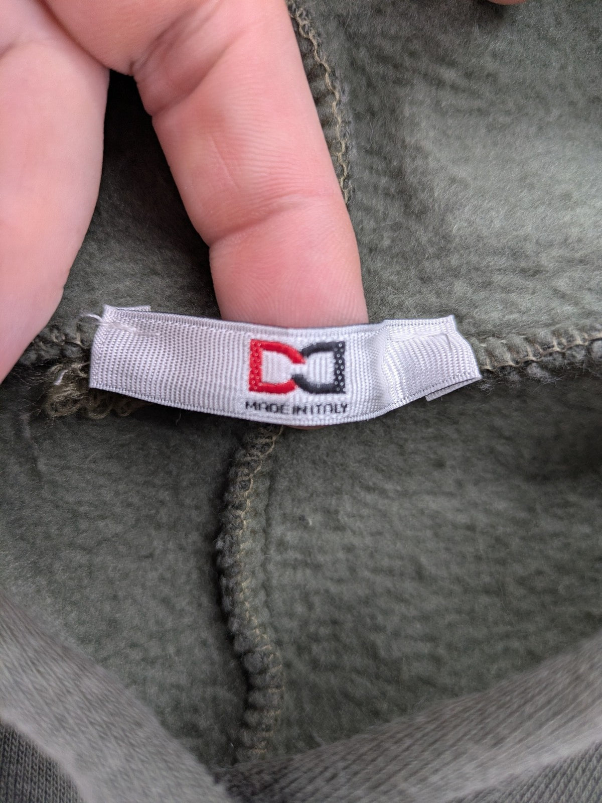 DCJ cream and olive green hoodie with cable knit pattern and graphic text sleeves.