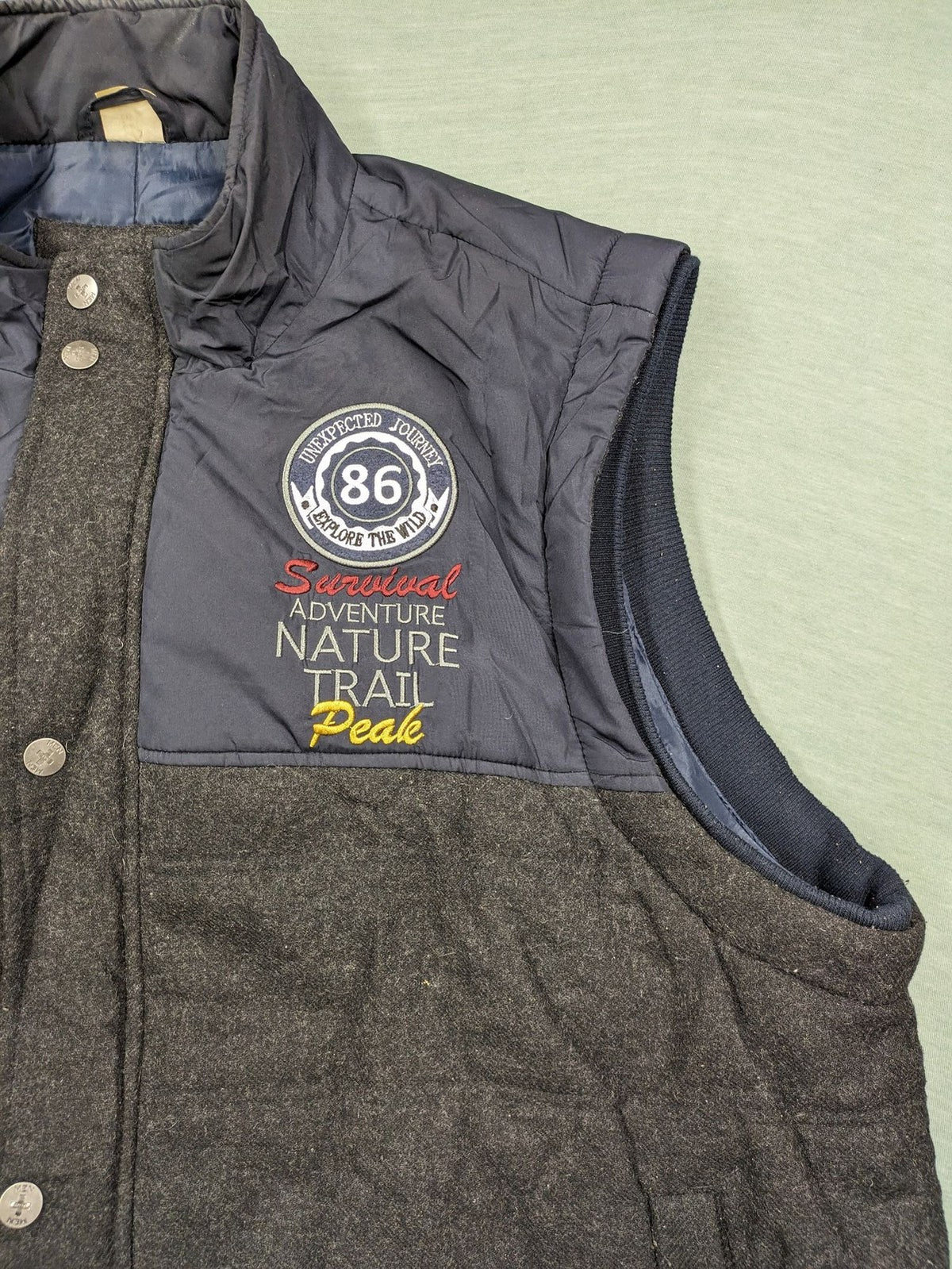 Men Plus grey and navy quilted vest with full zip and snap button placket.