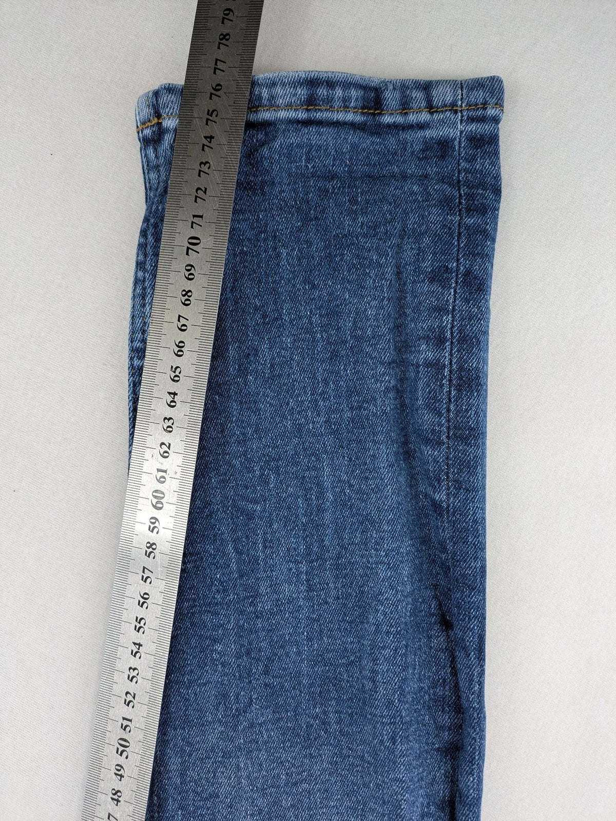 2Y Premium blue skinny jeans with distressed details and classic button fly.