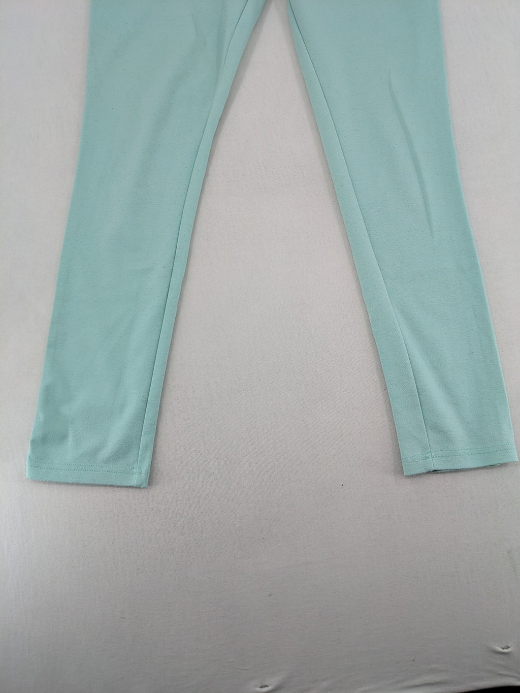 Dito green treggings with pull-on design, front pockets, and belt loops.