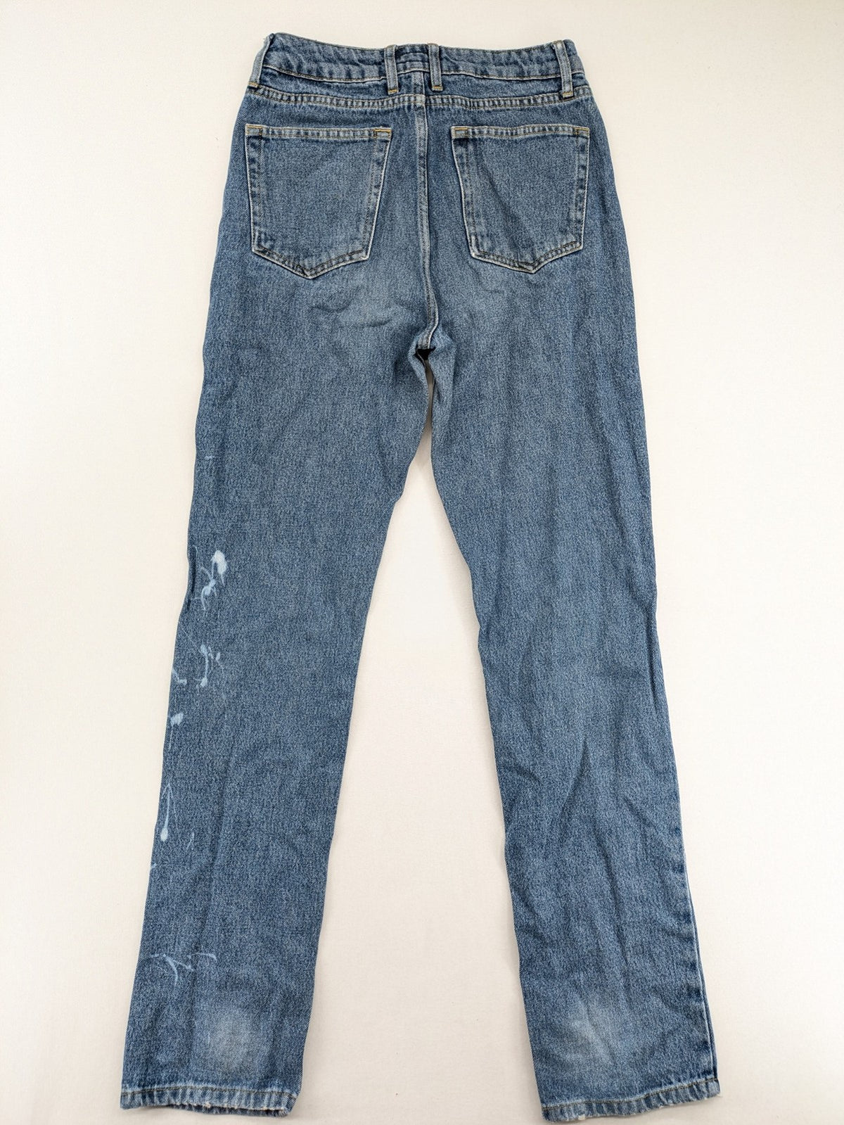 Castro Jeans blue straight leg jeans high waist with white paint splatter details.
