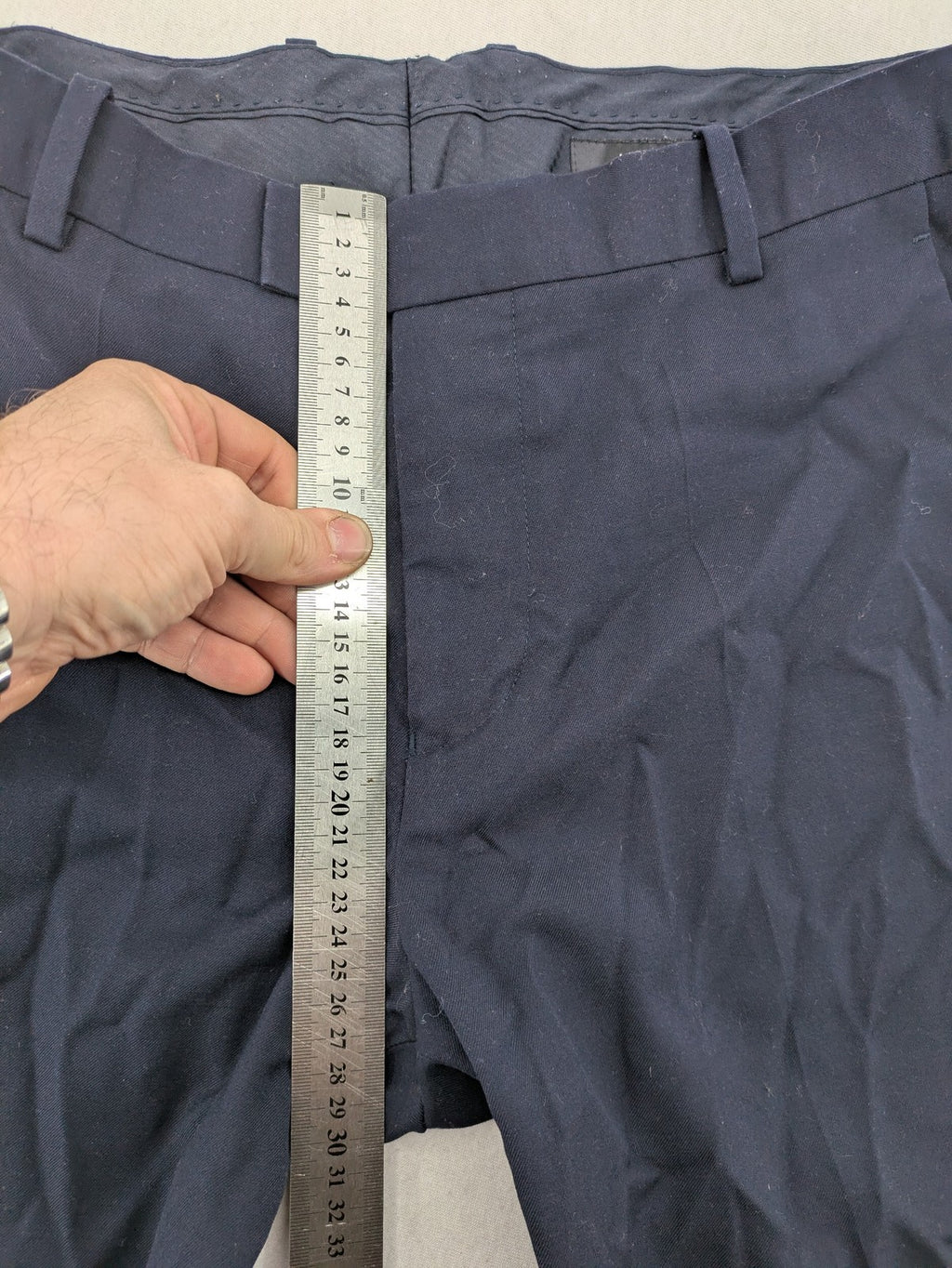 H&M navy slim fit executive suit trousers with flat-front design and side pockets.
