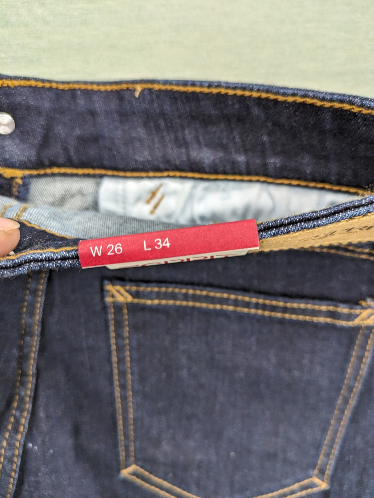 Esprit navy straight jeans with five-pocket style and yellow contrast stitching.