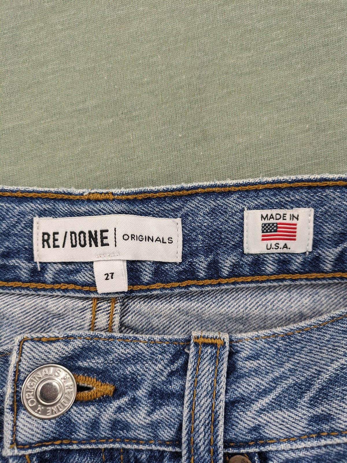Re/Done blue straight jeans high rise with button fly and raw hem detail.