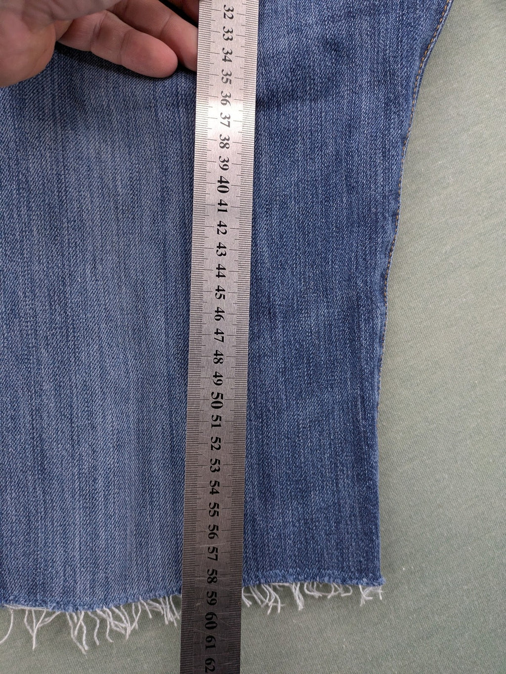 Levi's blue cut-off shorts with frayed hem, classic 5-pocket design, button fly.