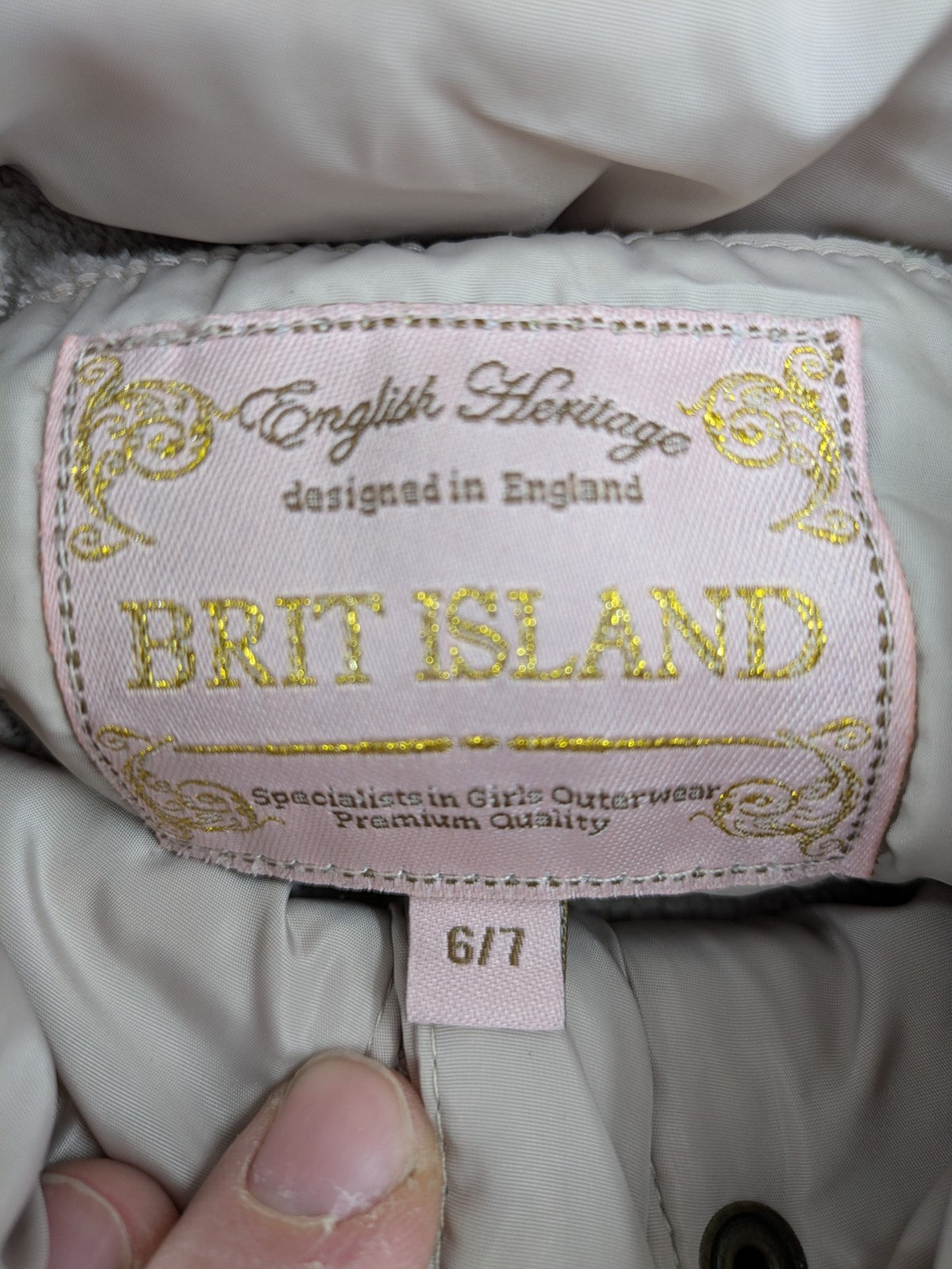 Brit Island beige puffer coat with fleece lining and faux fur hood detail.