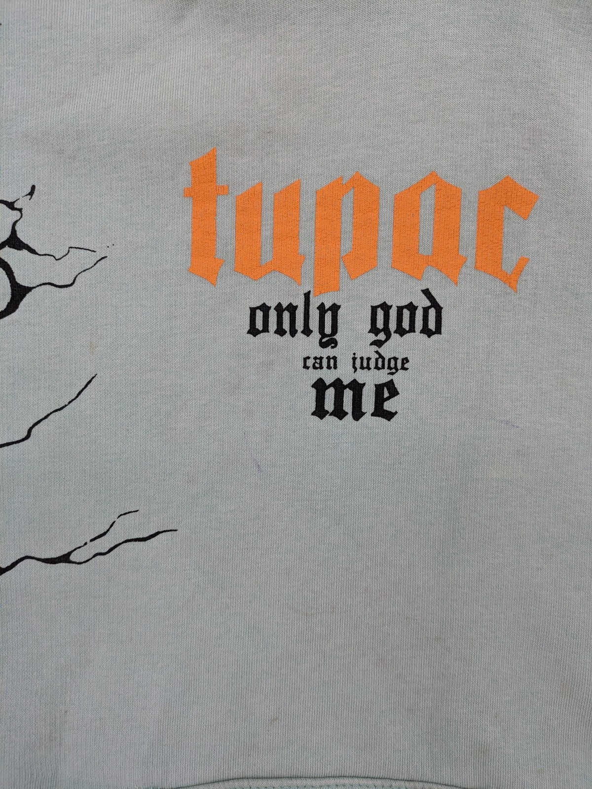 Tupac black and green zip-through hoodie with "Only God Can Judge Me" front print and angel wings graphic.