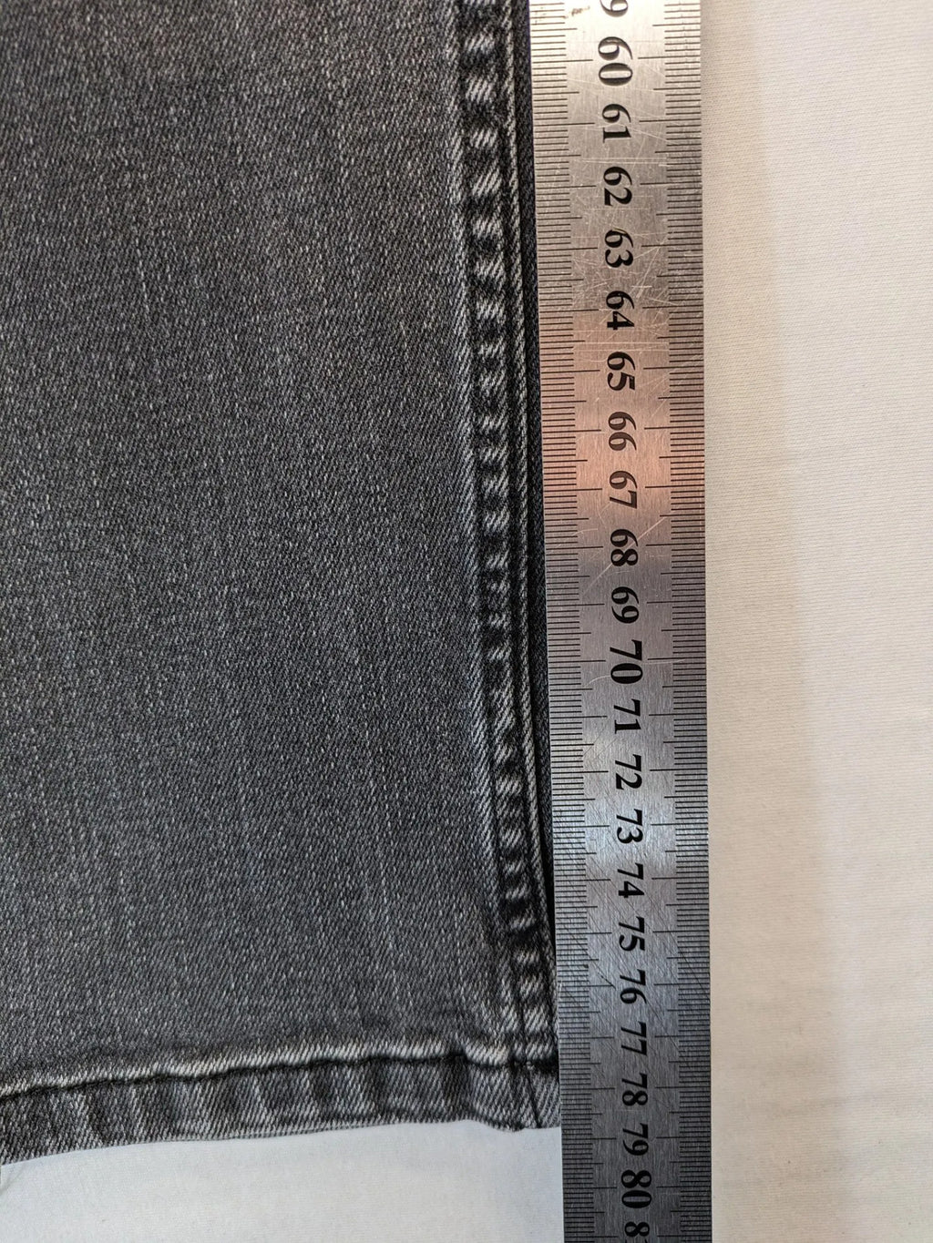 Denim grey straight jeans 5-pocket design with subtle brand details and zipper closure.