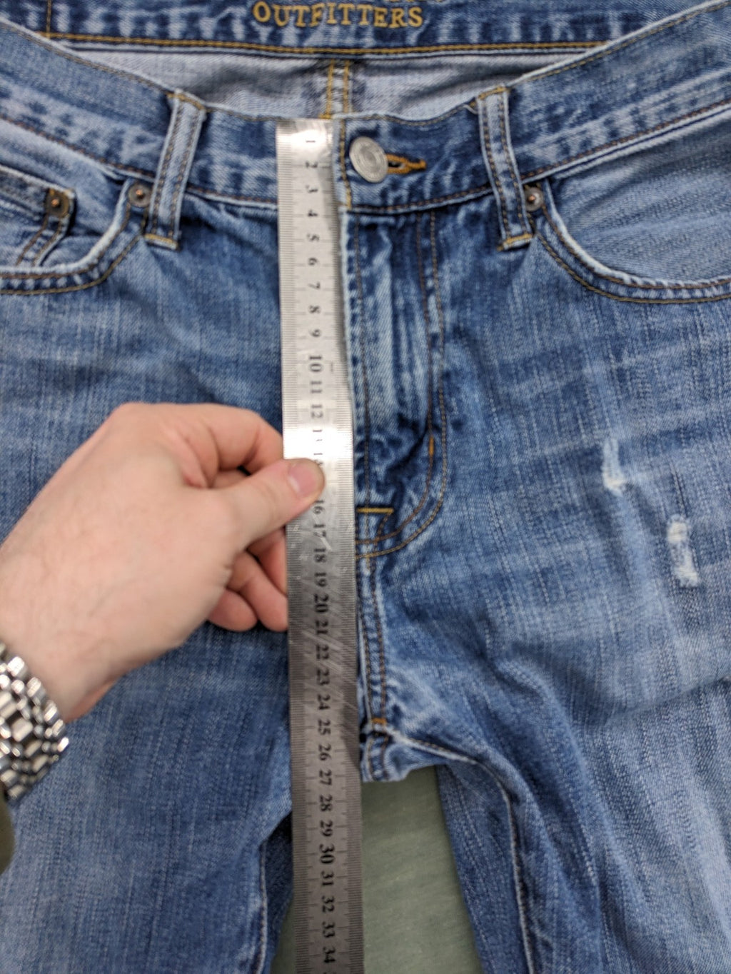 American Eagle Outfitters blue straight jeans with distressed detailing and classic five-pocket design.