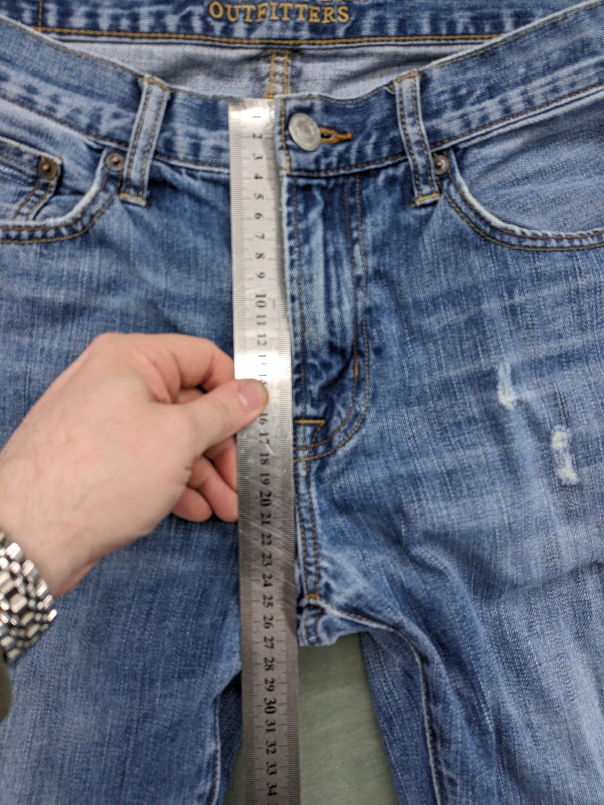 American Eagle Outfitters blue straight jeans with distressed detailing and classic five-pocket design.