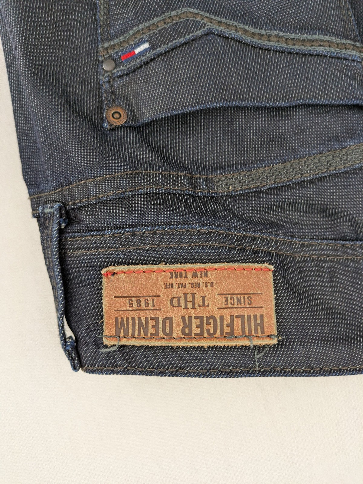 Hilfiger Denim blue straight jeans with double button closure and logo detail.